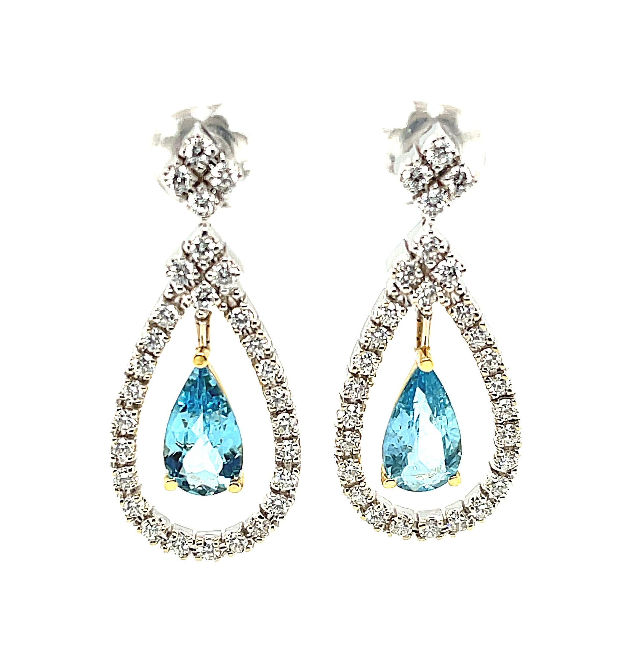 These stunning 18k white gold dangle earrings feature extremely fine, natural color aquamarines framed by diamond studded floating halos in an elegant and ultra-sophisticated design! Aquamarines of vibrant, saturated color and high quality are