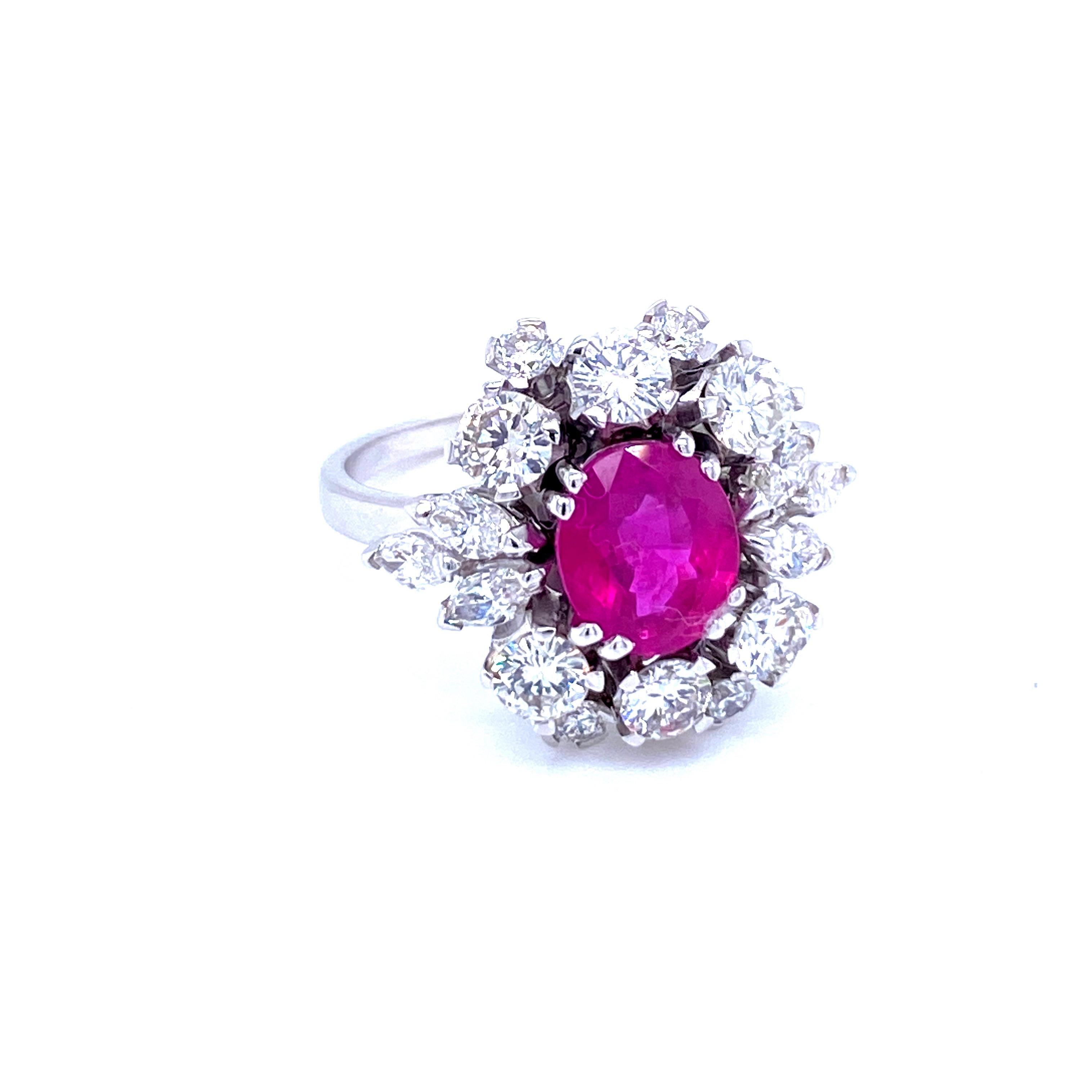 Exceptional 18k white Gold cluster ring features a 1.87 Carat oval-cut Natural Unheated Ruby, origin Burma, surrounded by round brilliant cut and Marquise Diamonds for a total approx. weight of 1.60 carats color H/I  Vs clarity.
The Ruby is