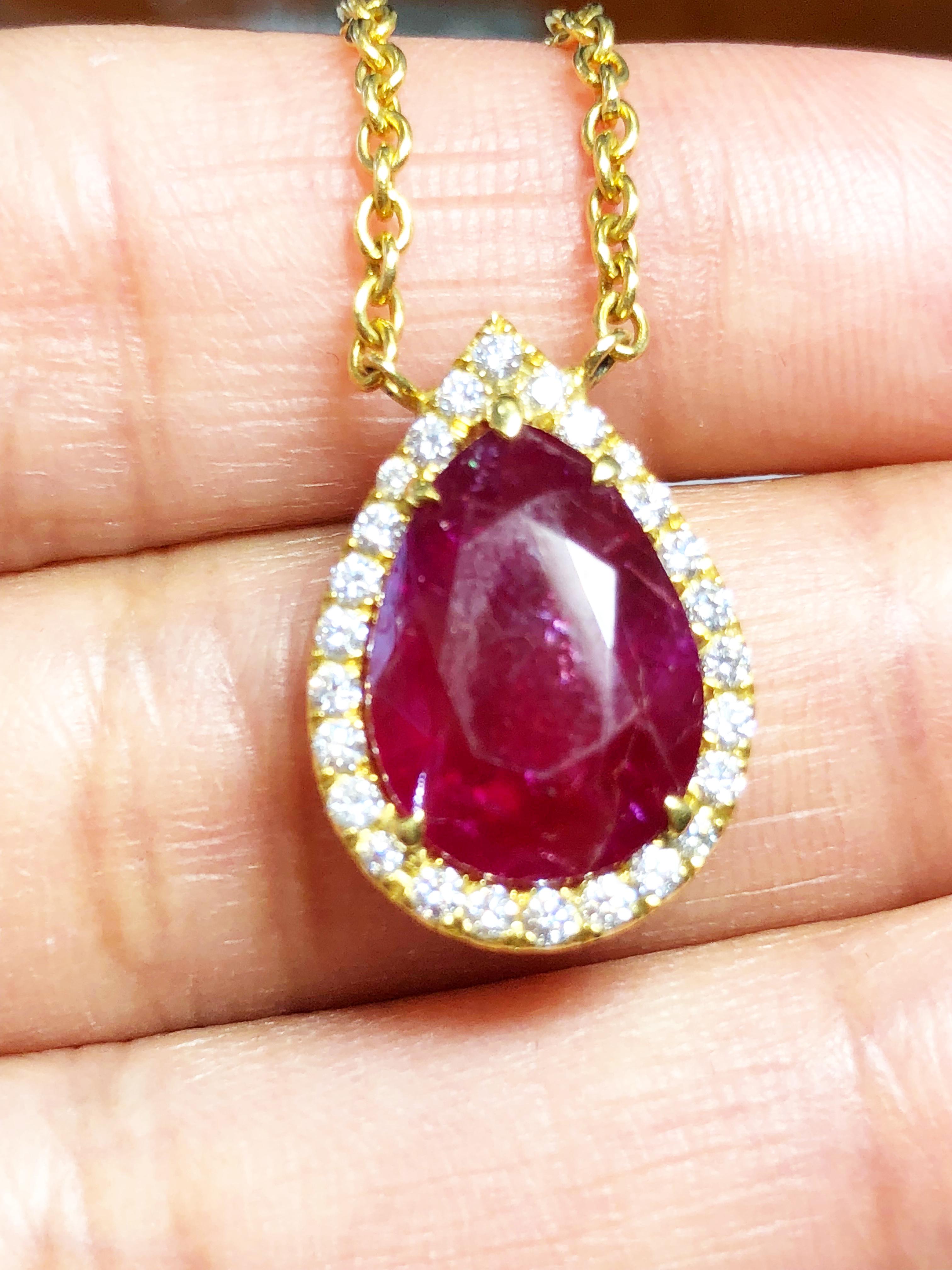 Fabulous deep red unheated 6.17 carat Burma ruby surrounded by white diamonds set in 18k yellow gold.  Length is 16
