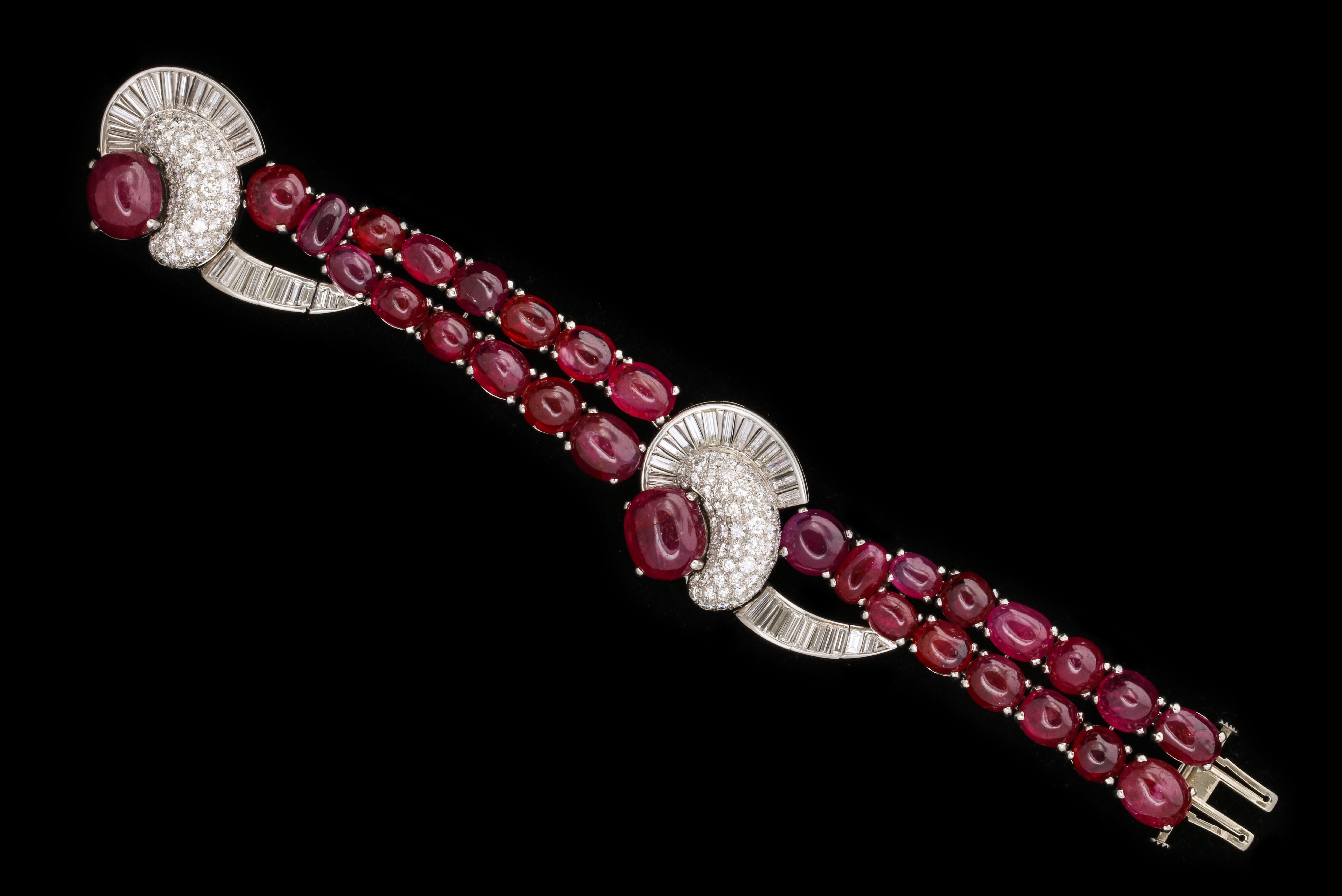 The bracelet with 2 central diamond floral designs has a jaw dropping layout of  AGL certified non heated Burmese rubies.

Made in 1940's 

It bears a mysterious illegible maker's mark

Provenance:

Full page spread in the 