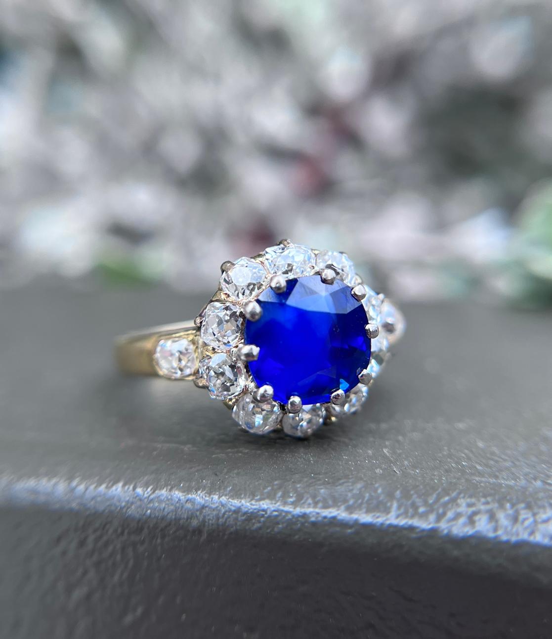 This stunning unheated Burmese sapphire displays the rich, velvety blue that these gemstones are so prized for. The sapphire weighs 2.30 carats and is surrounded by a halo of  10 dazzling old mine-cut diamonds weighing approximately 0.95 carats set
