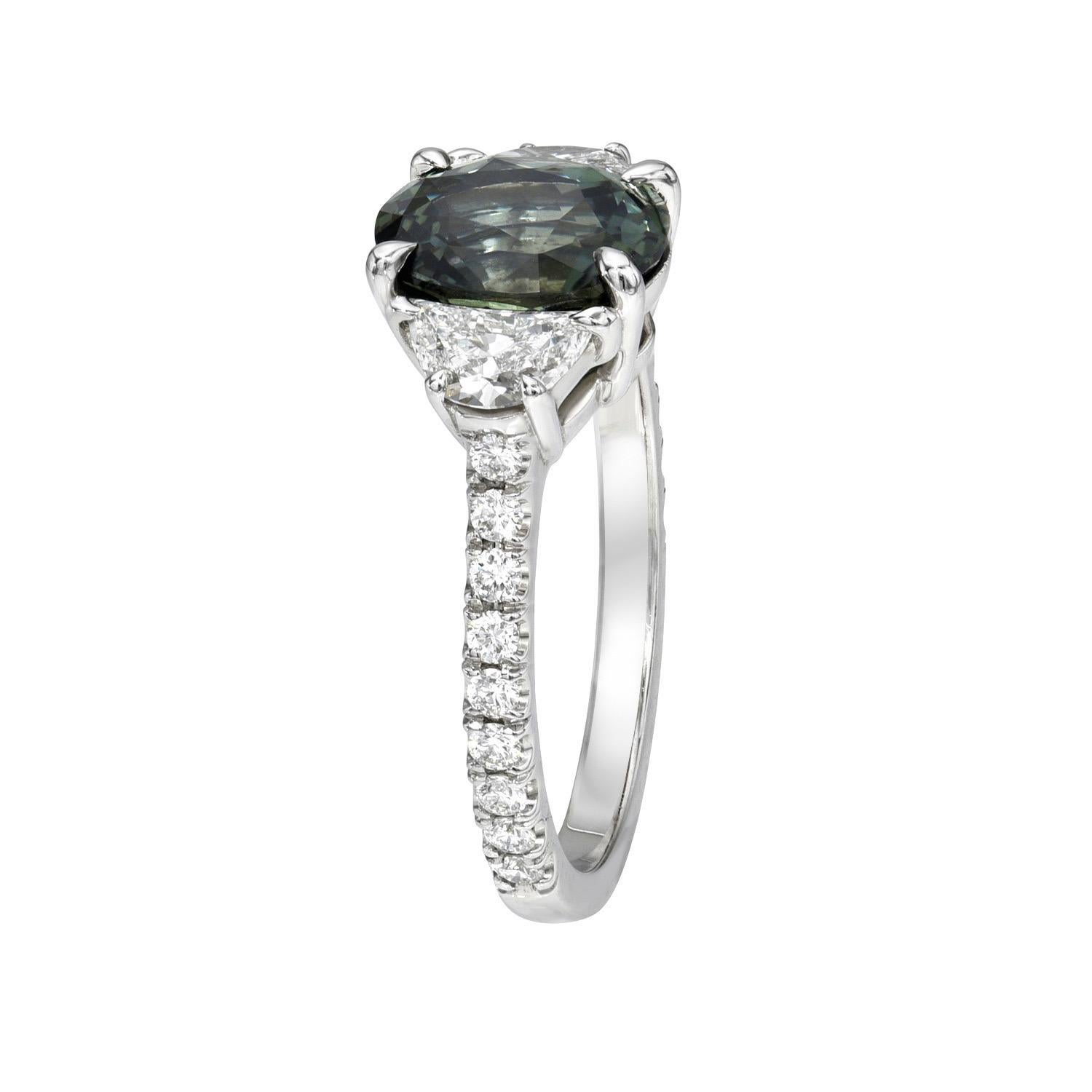 Exclusive 2.58 carat natural unheated Green Sapphire oval, three stone platinum ring, decorated with a pair of 0.54 carats, F color/VS2-SI1 clarity, crescent diamonds, and a total of 0.27 carats, round brilliant diamonds.
Size 6. Re-sizing is