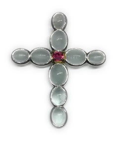 A Silver Cross Pendant set with Milky Aquamarine & an Unheated Pink Sapphire.