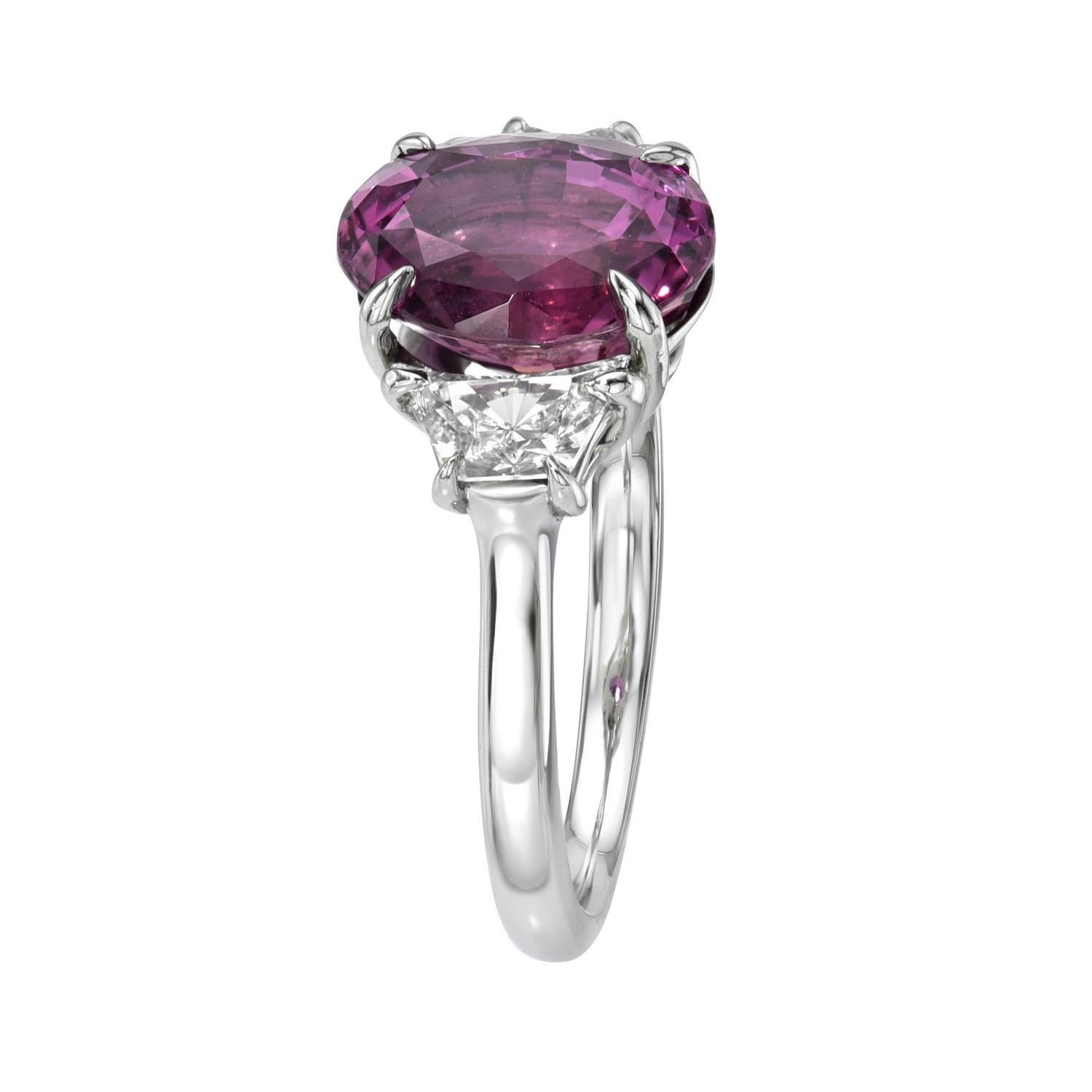 Spectacular 4.08 carat natural, unheated Purplish Pink Sapphire oval, three stone platinum ring, flanked by a pair of 0.60 carat, F/VS2-SI1 Crescent Trapezoid diamonds.
Ring size 6. Resizing is complementary upon request.
A GIA gem certificate will