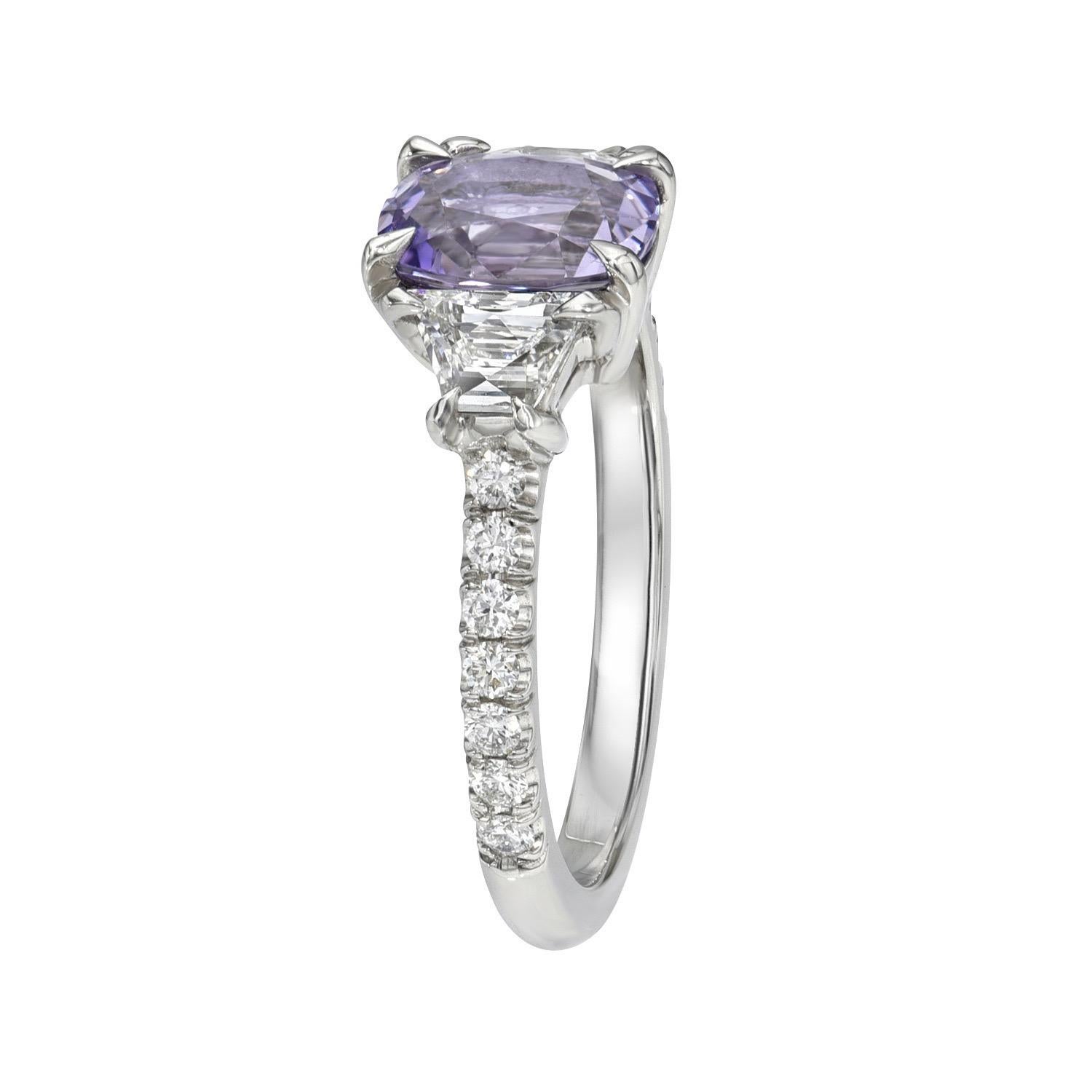Very attractive 1.41 carat unheated Lavender Sapphire cushion, three stone platinum ring, decorated with a pair of 0.45 carats, E color/VS2-SI1 clarity, French cut trapezoid diamonds, and a total of 0.20 carats round brilliant diamonds.
Size 6.