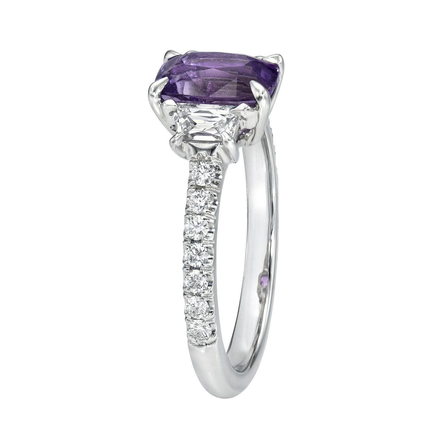 Striking 1.60 carat unheated Purple Sapphire cushion, three stone platinum ring, flanked by a pair of 0.32 carat, H/SI1 French cut Trapezoid diamonds and a total of 0.19 carats of round brilliant diamonds
Ring size 6. Resizing is complementary upon
