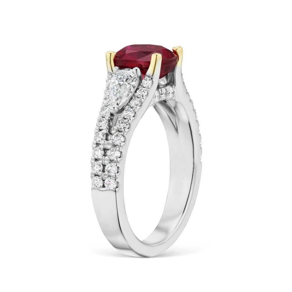 UNHEATED RUBY RING
More dynamic than a classic three stone ring, this ring features two pear
shaped side diamonds, surrounded by a delicate split diamond band.
Unheated Mozambique Ruby 2.36cts, Certified By GRS Lab And its
Pigeon Blood Color.
Item: