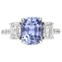 Vintage Unheated Blue Sapphire Three-Stone Platinum Ring with Cushion and Round Diamonds