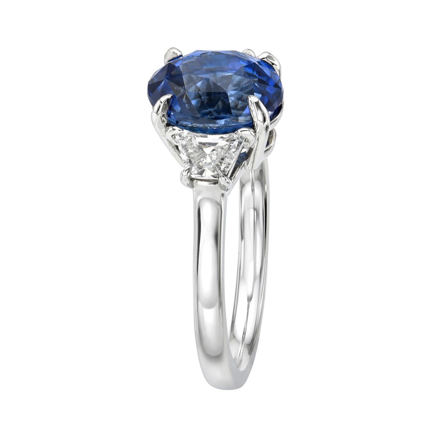 Unheated 3.47 carat Ceylon Blue Sapphire oval, three stone platinum ring, flanked by a pair of 0.45 carat, F/VS2-SI1 Crescent Trapezoid diamonds.
Ring size 6. Resizing is complementary upon request.
The CDC gem report is attached to the image