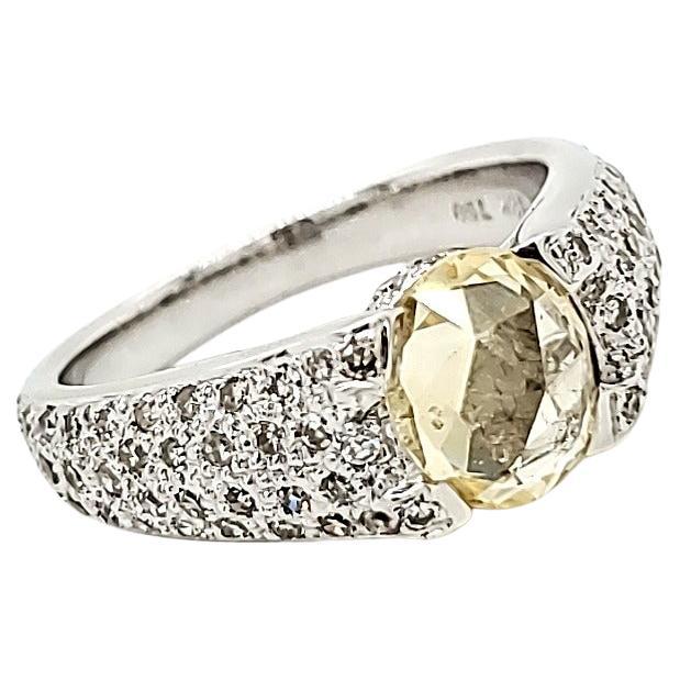 Unheated Yellow Sapphire Rose Cut and Diamond Ring on 18 K white gold.

An interestingly faceted Rose Cut Unheated yellow sapphire sits atop a bevy of old cut diamonds that surround the shank all the way around.

It is seldom a ring has this diamond