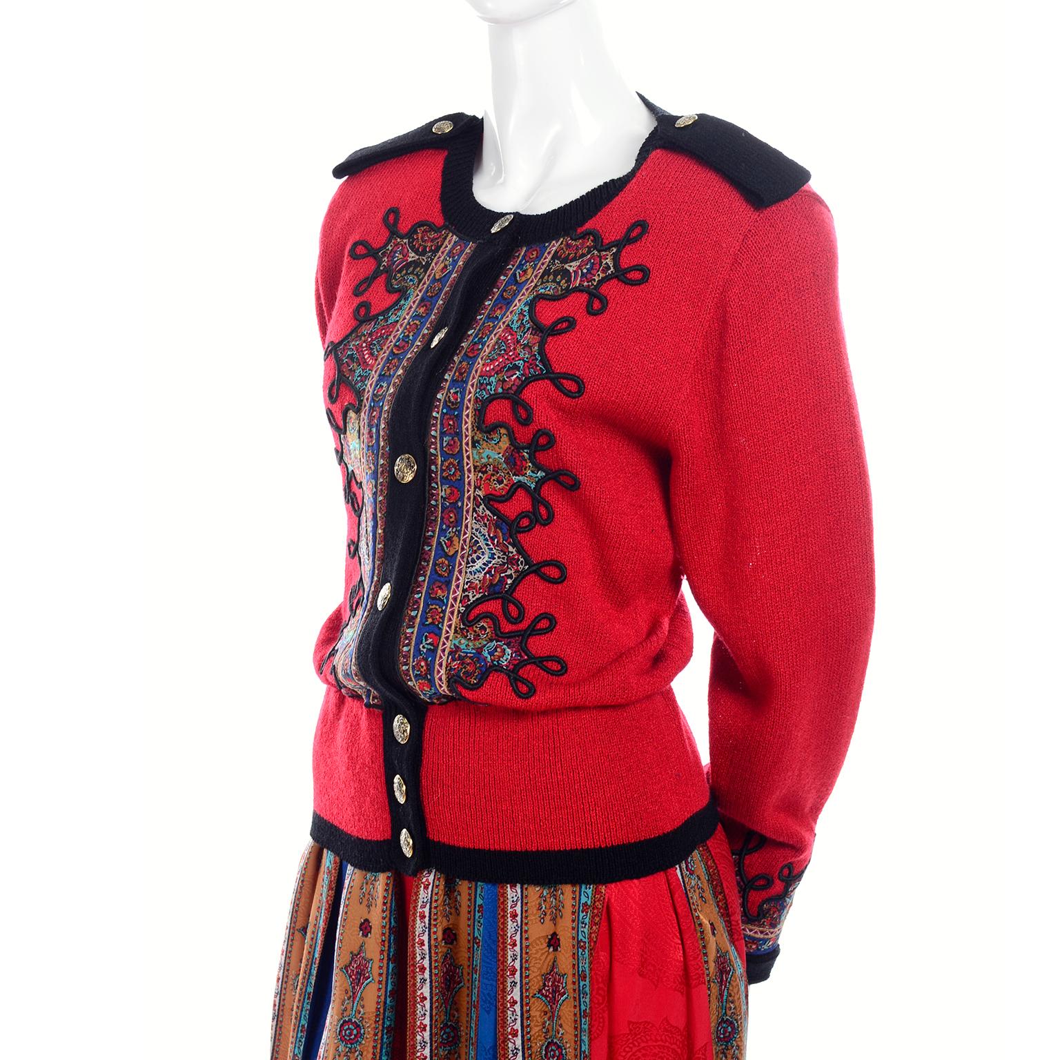 We love this 2 piece skirt and top vintage ensemble from Anne Crimmins.  This Uni Collection skirt and Sweater is so current looking with its pattern mixing style.  The top is red with patterned detailing around the front buttons.  The silk skirt