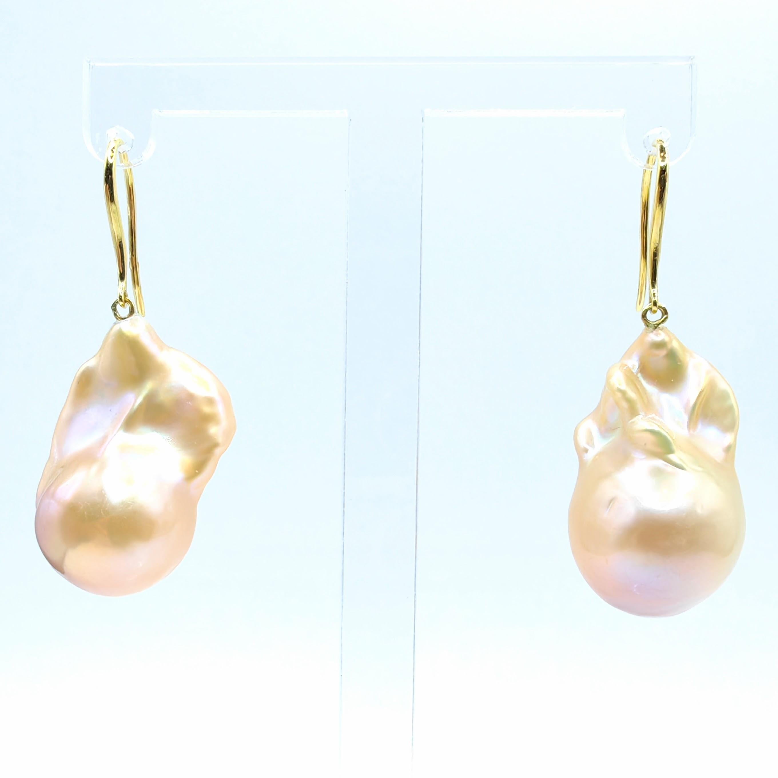 Indulge in the captivating allure of our Unicorn Hue Golden Baroque Pearl Drop Earrings, meticulously crafted to captivate and inspire. These remarkable earrings feature stunning Freshwater Cultured Baroque Pearls, boasting an enchanting unicorn hue