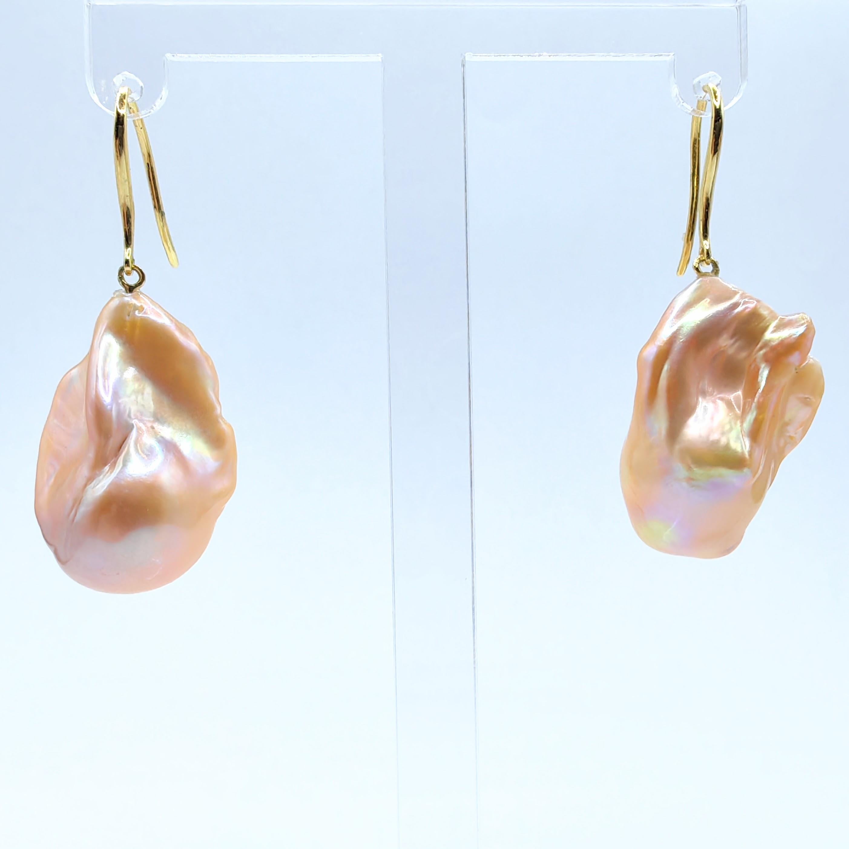 Indulge in the captivating allure of our Unicorn Hue Golden Baroque Pearl Drop Earrings, meticulously crafted to captivate and inspire. These remarkable earrings feature stunning Freshwater Cultured Baroque Pearls, boasting an enchanting unicorn hue