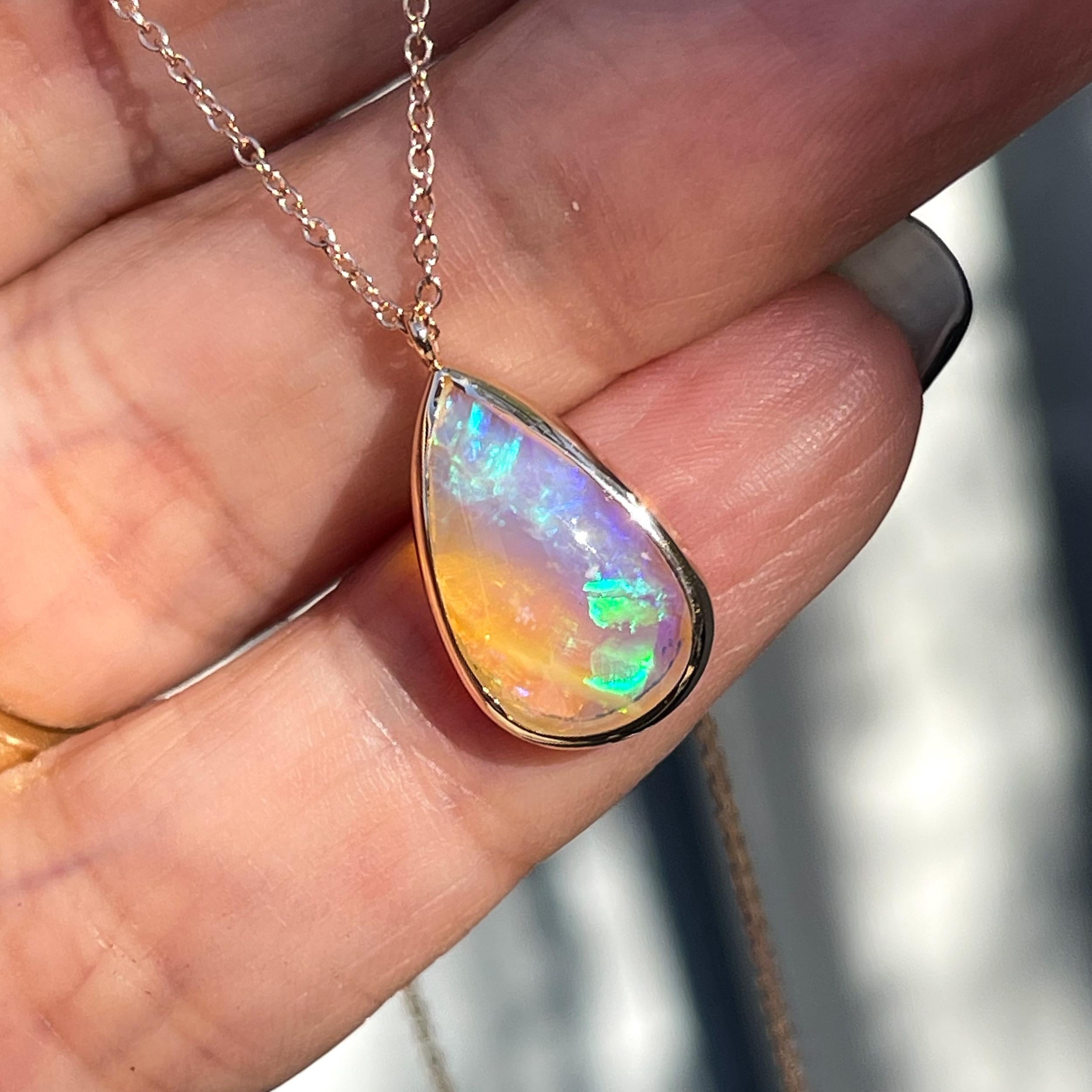 Impulsive color floods the façade of this Australian Opal Necklace. With its crystal bodice set in rose gold, the opal pendant diffuses light, allowing covert colors to emerge. Flashes of turquoise, lavender and green transiently illuminate the pink