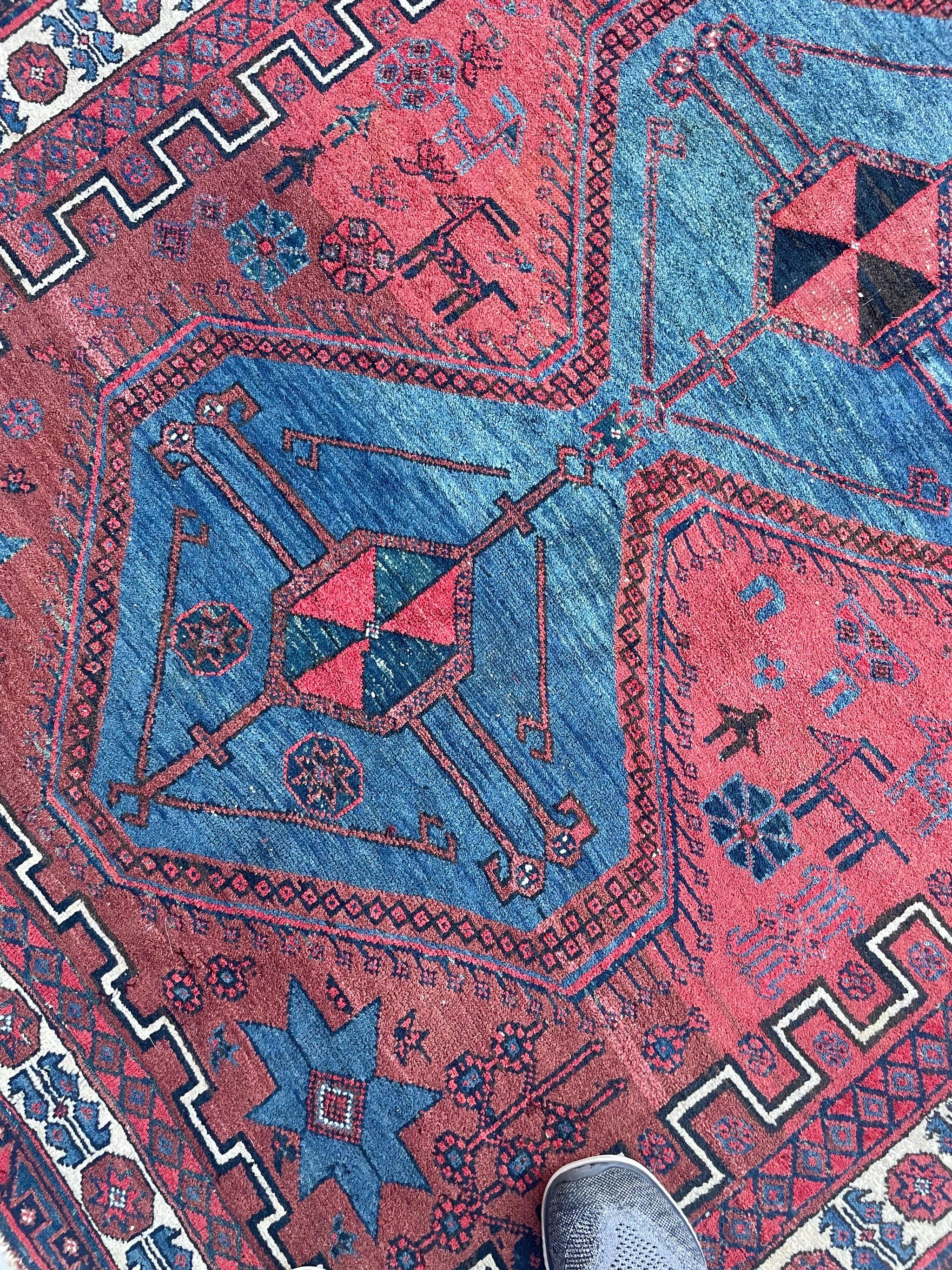 Unicorn Vintage Shiraz Rug  Village Life Woven Throughout  Clay, Ice Blue, Charcoal

About: One of my personal favorites - something about the colors, the design, and the intent with the camels, gazelle, deer, and birds woven in with human subjects