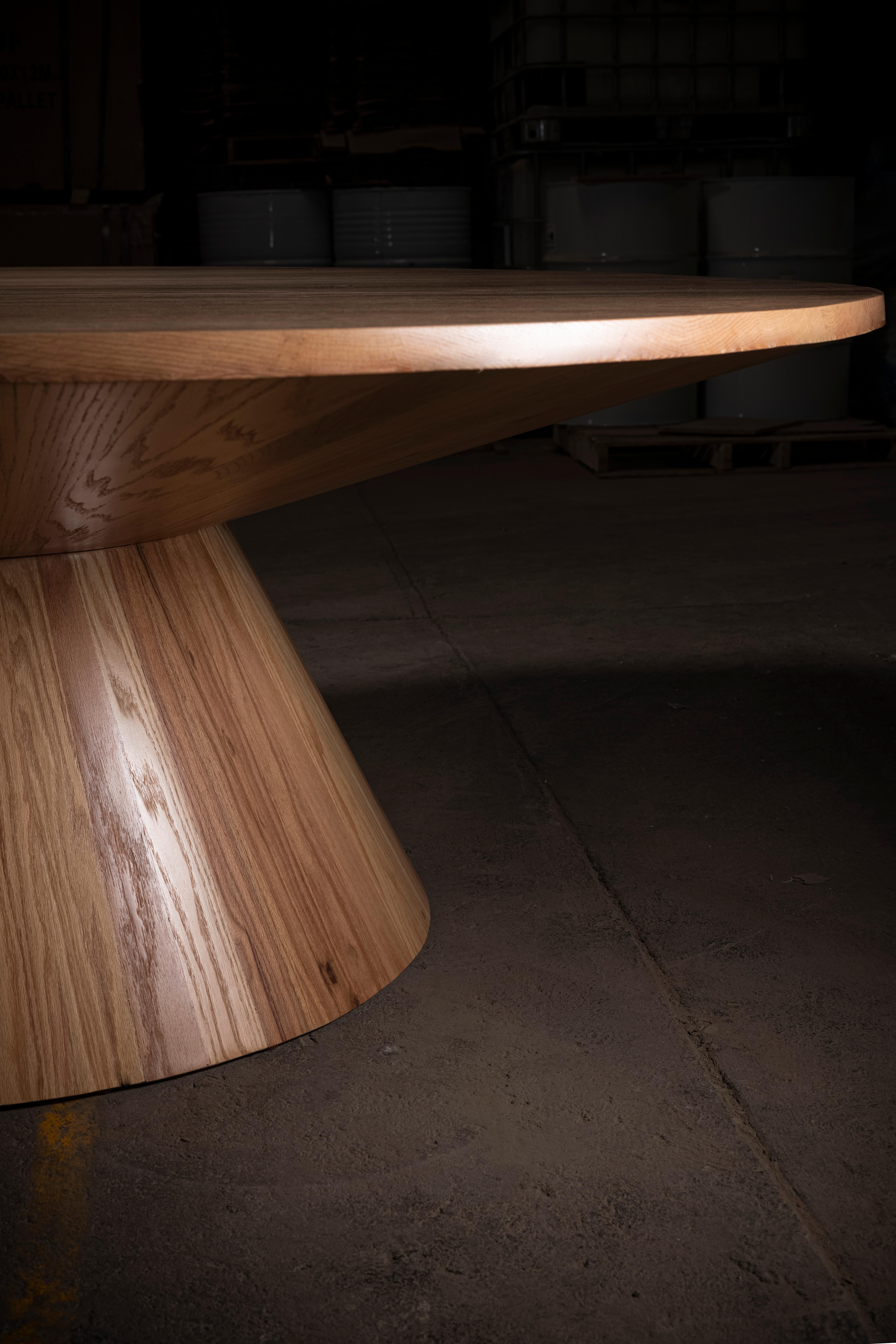 Handcrafted solid oak circular dining table.
Circular piramid shape pedestal.
Natural oak look with a coat of clear laquer for protection.