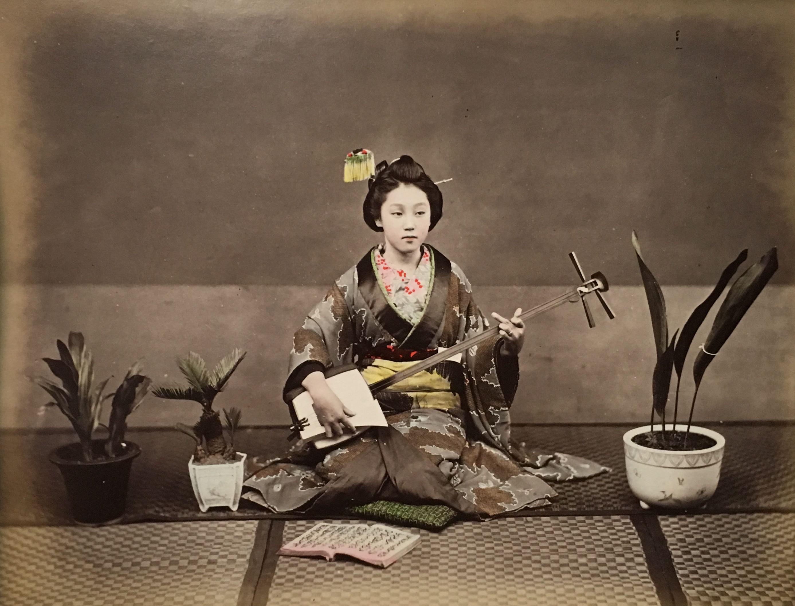 Unidentified Photographer  Color Photograph - Girl Playing Instrument, c. 1880