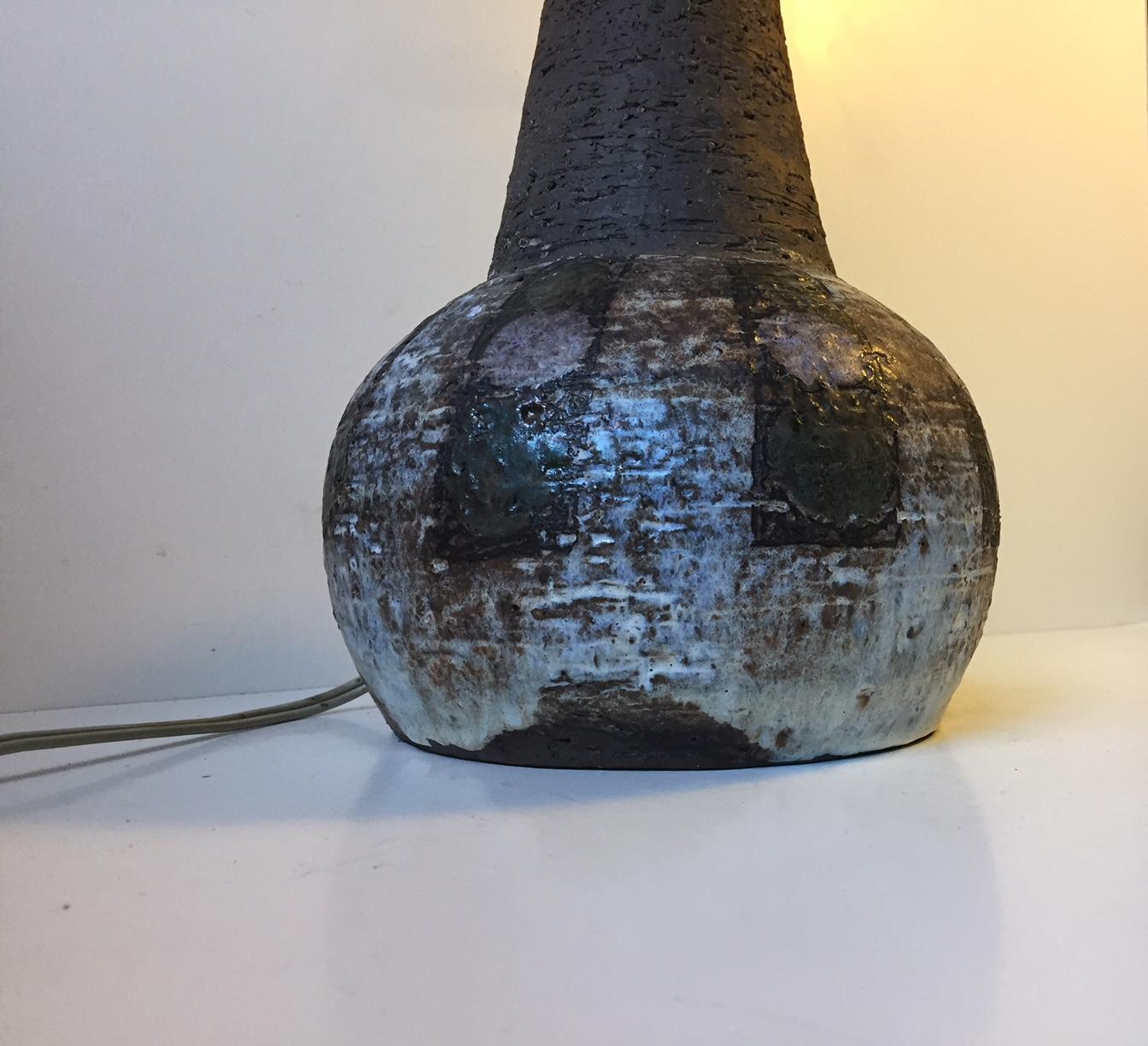 This is a unique table lamp base composed of partially glazed stoneware. The abstract motif has pink and green dots to the base. The bottom is signed: Sejer, Unik, Denmark.