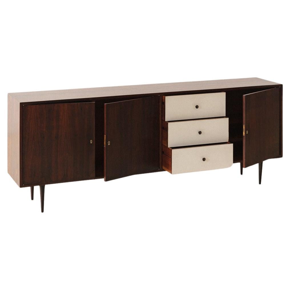 This credenza was designed in the 1950s by Geraldo de Barros (1923-1998) and produced by Unilabor. De Barros designed and projected furniture based on his constructive references related to Concrete Art.

Its structure is made of Rosewood with