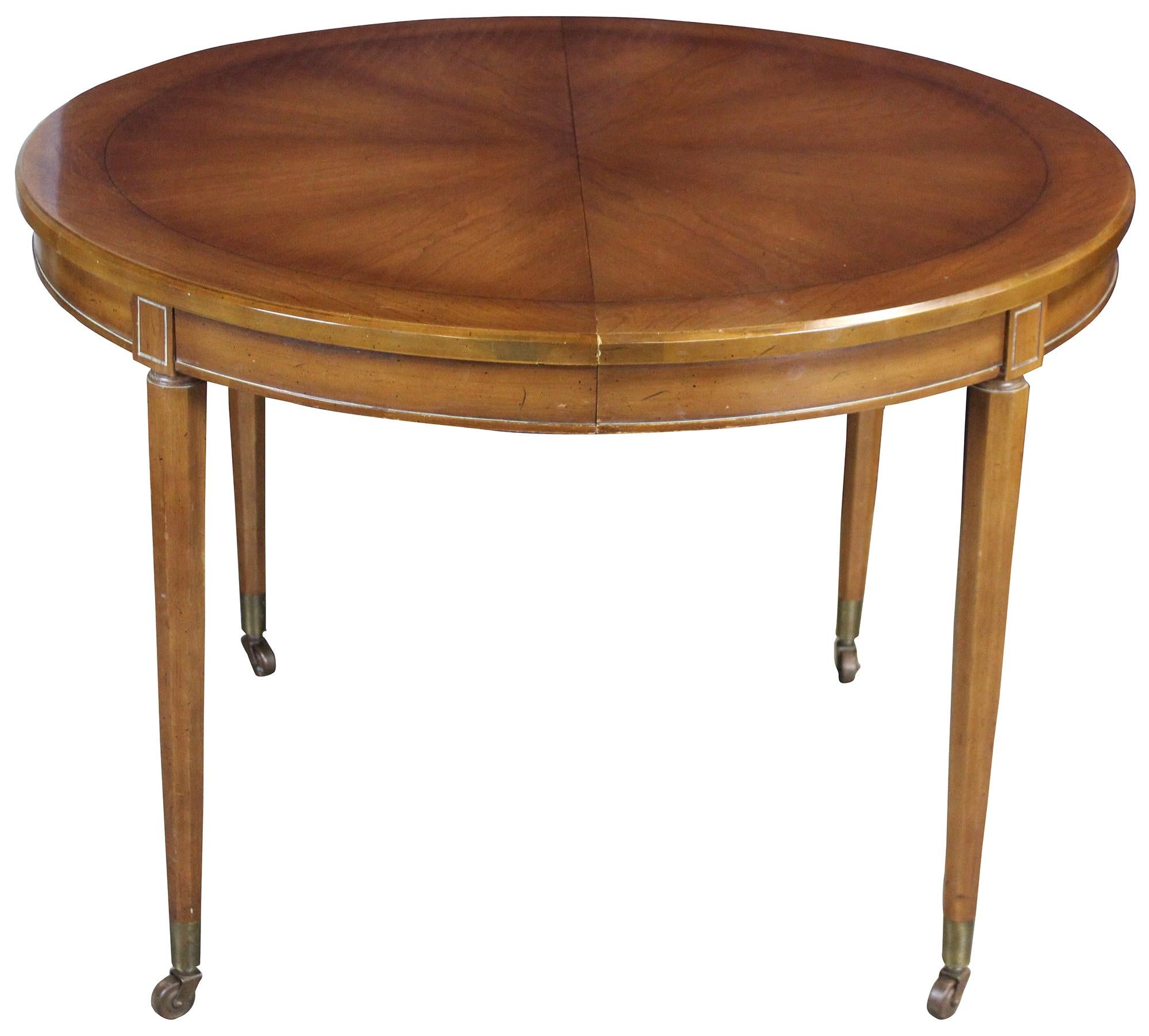 Italian Provincial dining table and chairs by Union National of Jamestown New York, circa 1950s. A round extendable table made from fruitwood with 4 dining chairs original Parma finish. 

Table features octagonal tapered legs leading to