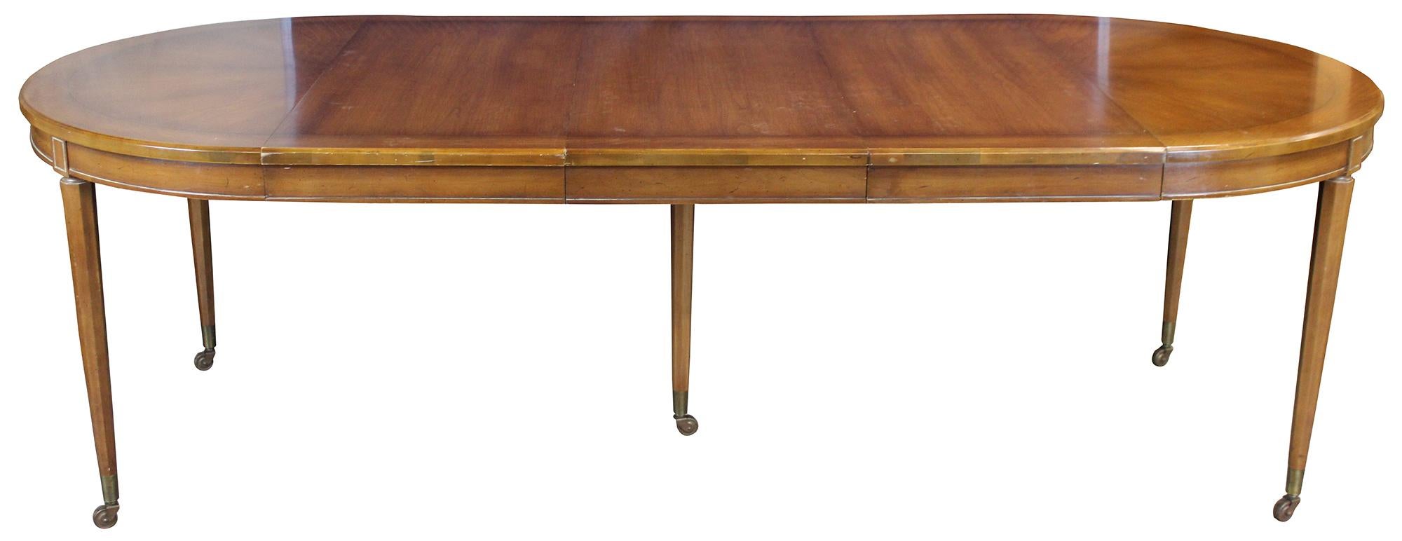 Italian Provincial dining table by Union National of Jamestown New York, circa 1950s. A round extendable table made from fruitwood with Parma finish. Features octagonal tapered legs leading to casters.

Measures: 96