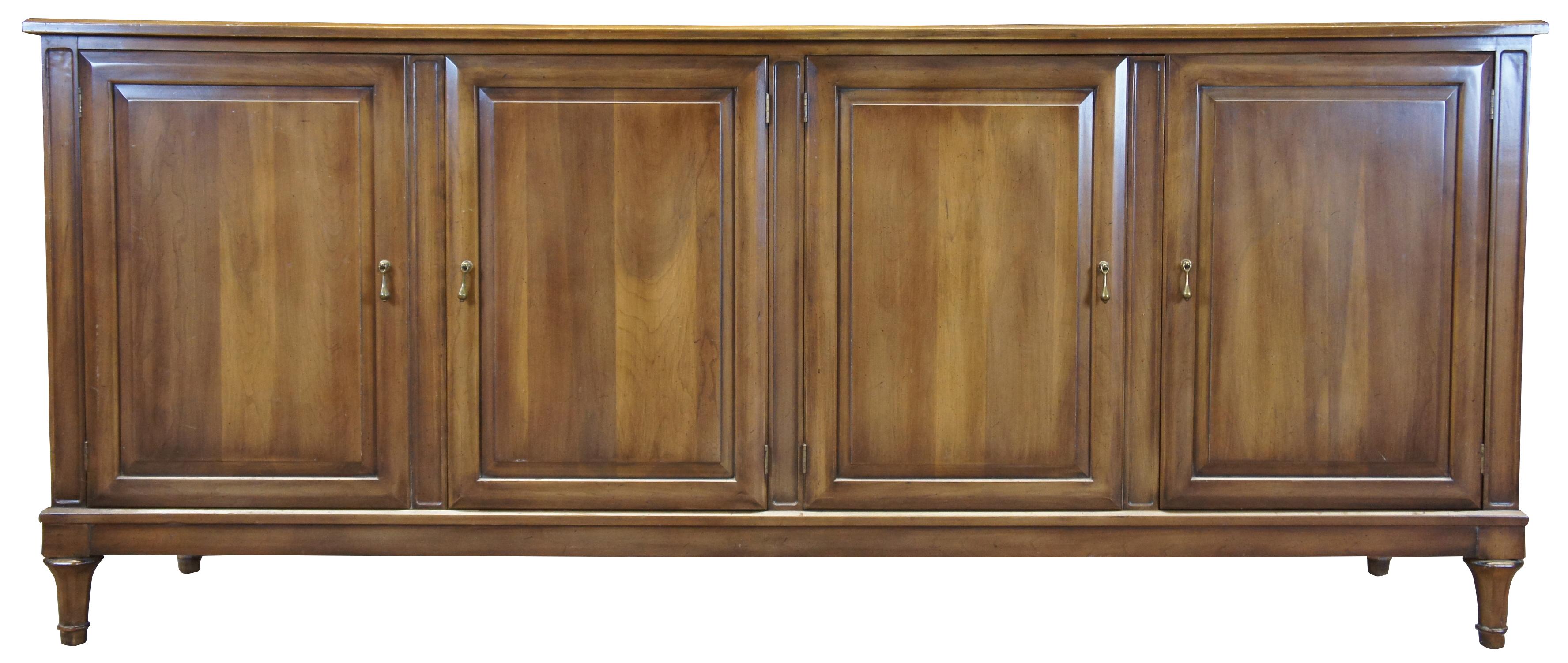 Italian Provincial Sideboard by Union National of Jamestown New York, circa 1950s.     Features a streamlined design in classic mid century modern form.  Made from fruitwood with Parma Finish. Includes two cabinets that open to three drawers along