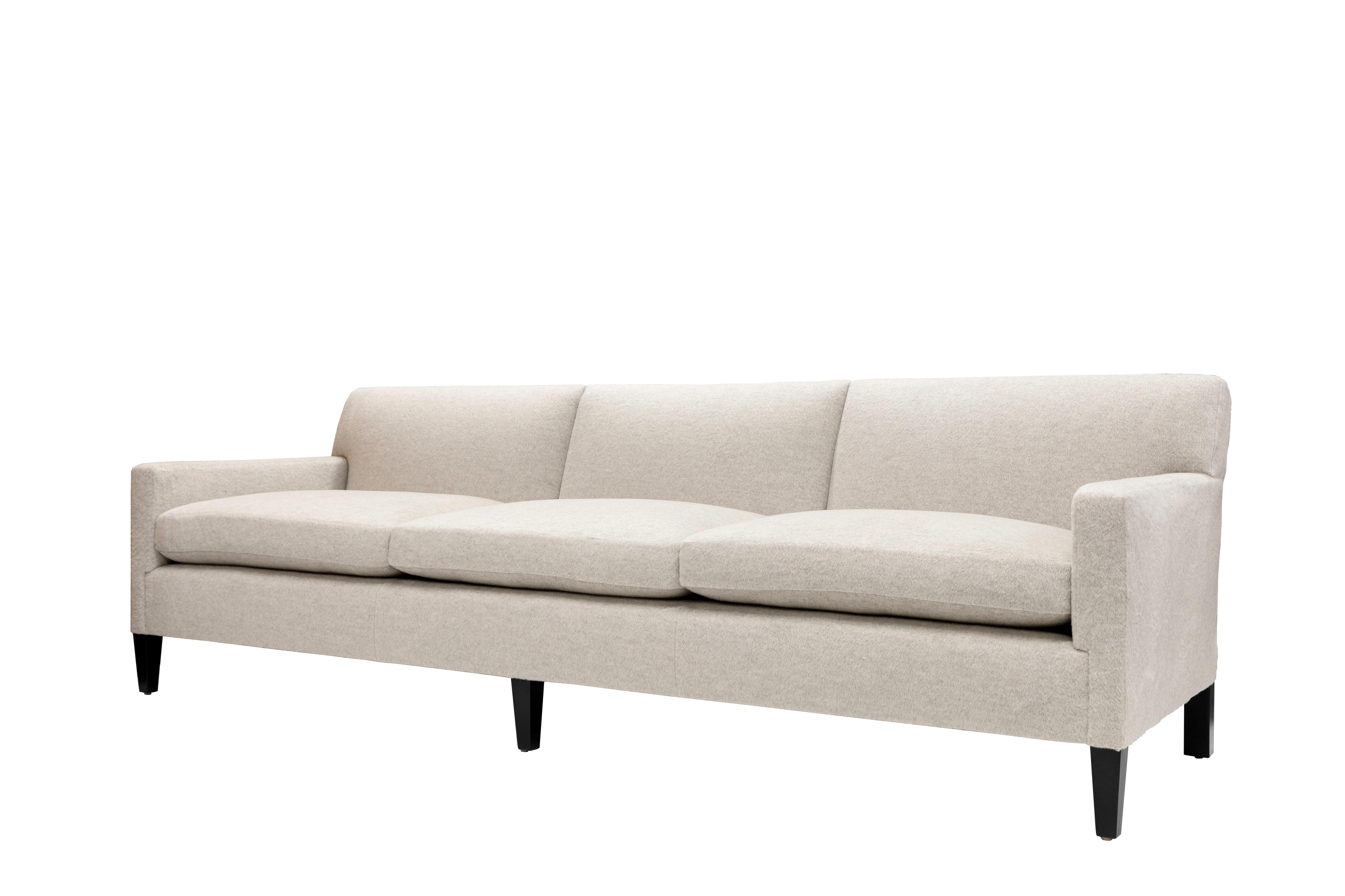 The Union Sofa has a tight upholstered back with three loose seat cushions. Tapered front legs and squared back legs are made of blackened hardwood.

The Union Sofa is a made to order item and hand crafted in the USA. 
Customer's own material is