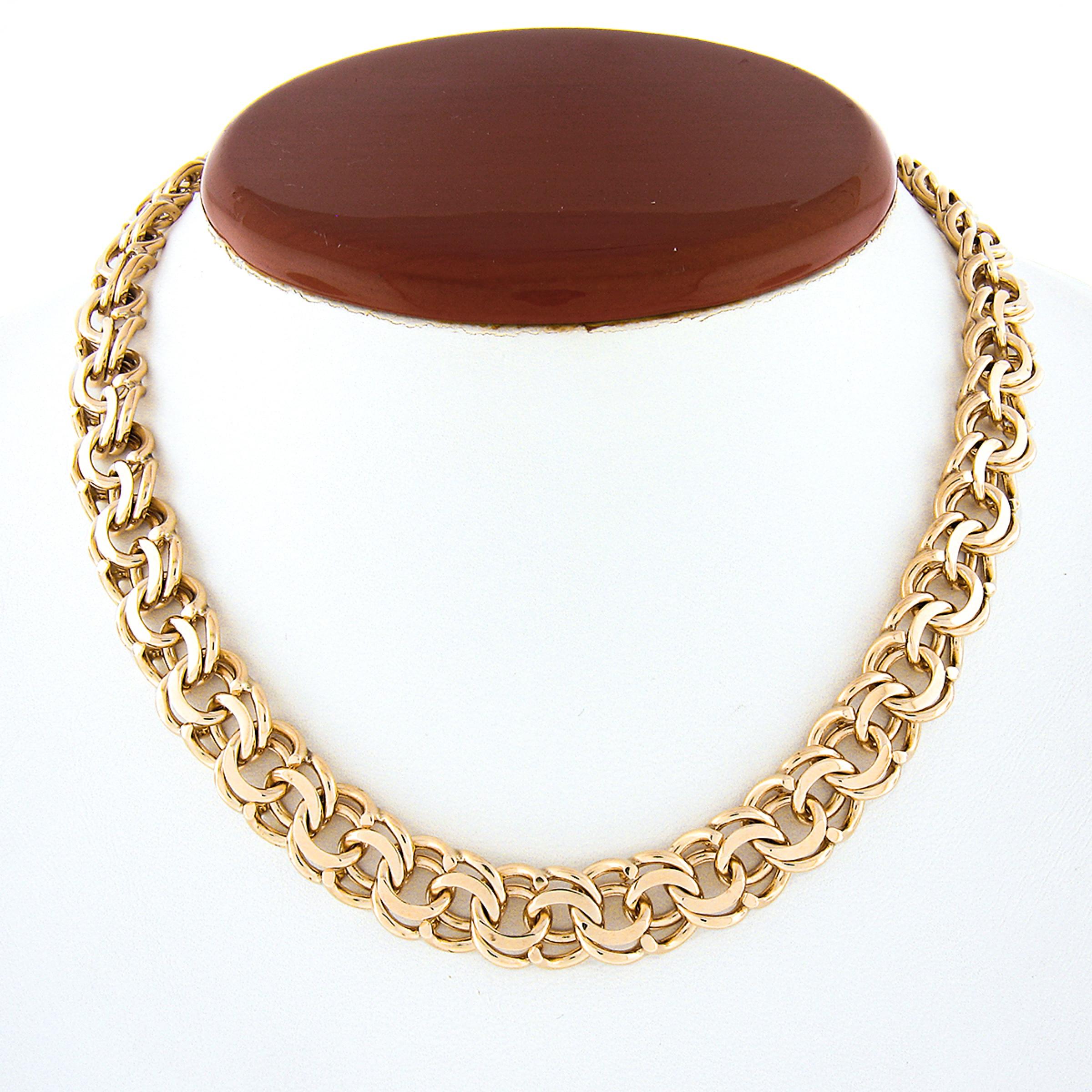 Here we have a gorgeous chain choker necklace crafted in solid 14k yellow gold featuring a double loop and open ring link with a nice high polished finish throughout. This substantial chain measures 15.25 inches in wearable length and 11.2mm wide,