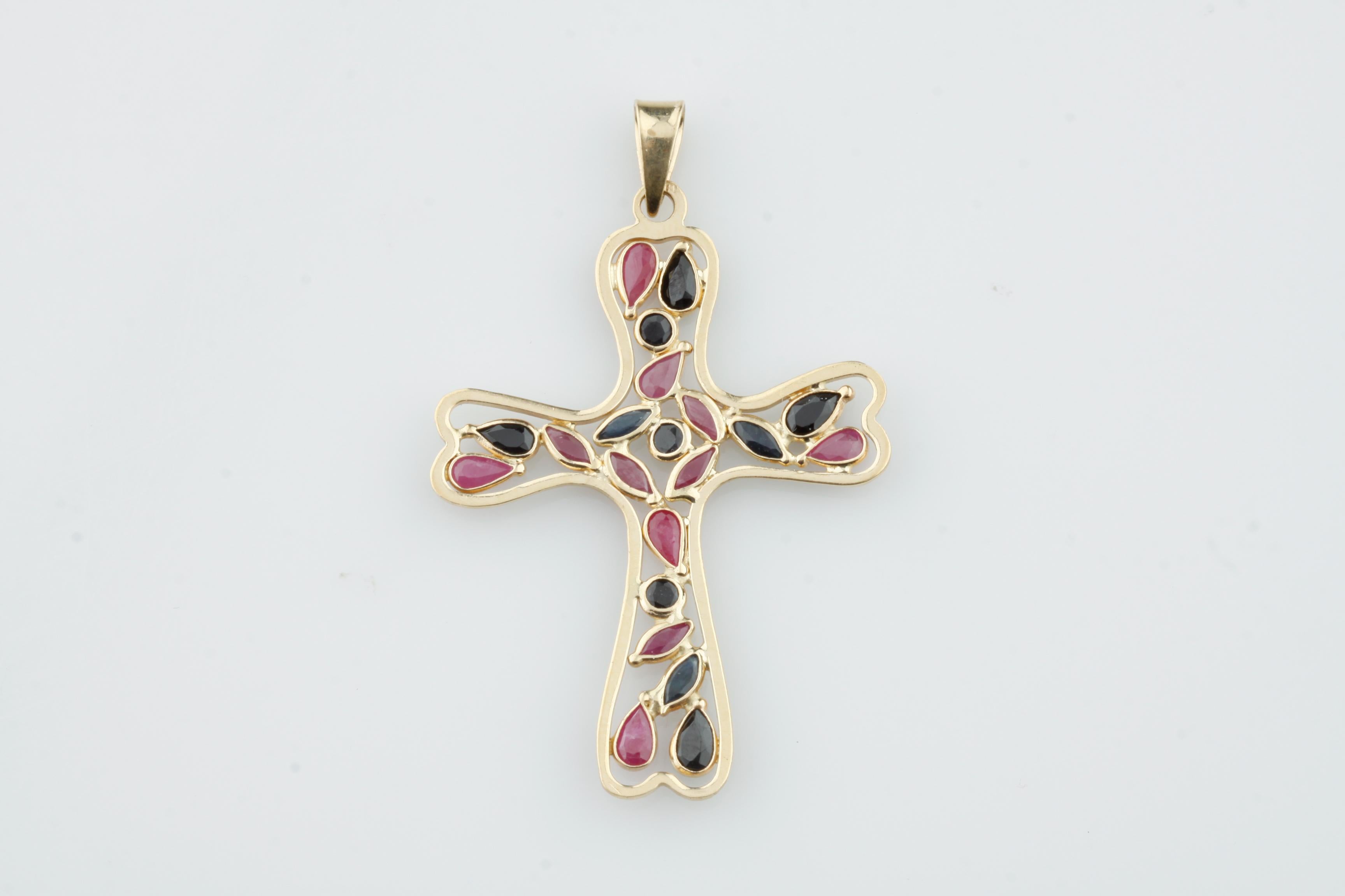 Gorgeous Organic 14k Yellow Gold Cross Pendant
Features Bezel-Set Pear, Round, and Marquise-Cut Rubies and Sapphires Suspended within Cross
Creates an almost stained-glass appearance
Total Length of Cross (Including Bail) = 54 mm
Width of Cross = 36