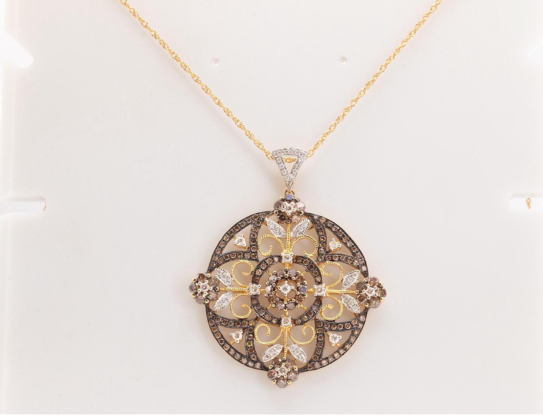 This stunning unique pendant features approximately 1.5 carats of round brilliant diamonds. The white diamonds are G-H in color and SI1-SI2 in clarity, while the rich brown diamonds are VS-SI in clarity, creating a captivating contrast. Elegantly