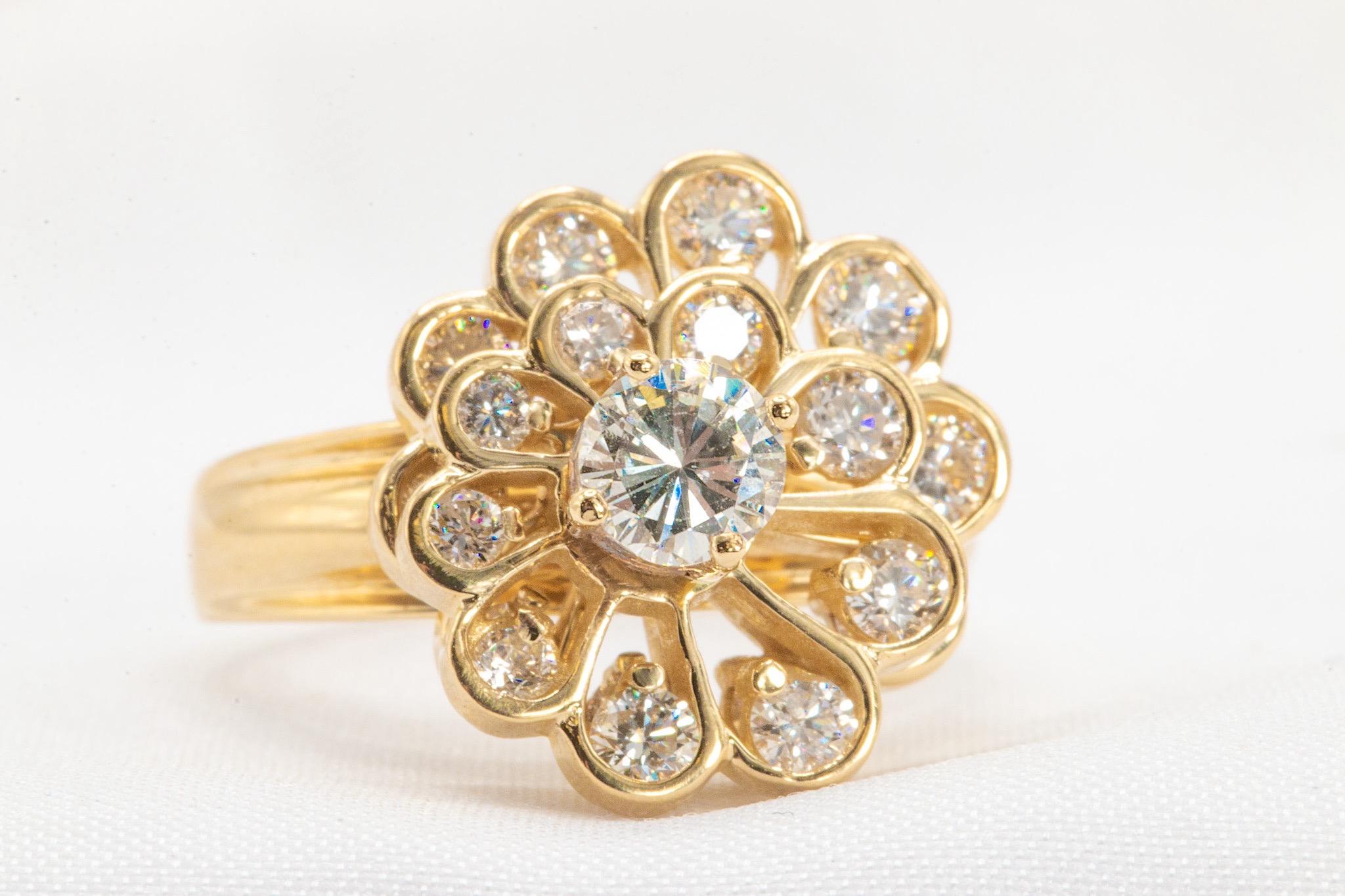 Unique 14k Yellow Gold Floral Diamond Spinner Ring 1.42 Carat Total 

This enchanting ring has a contemporary feature allowing two flowers to freely spin in a halo beneath the center diamond. It's the perfect elevated piece for those who like