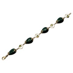 Bracciale a spirale con malachite e peridoto 14Y unico nel suo genere