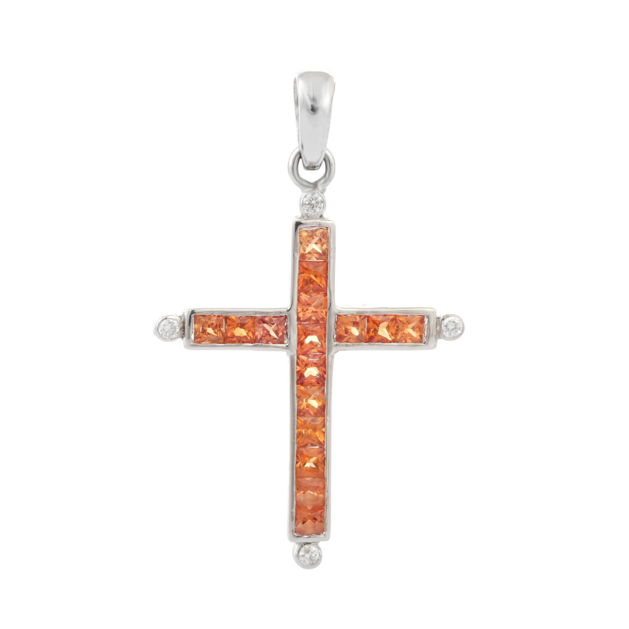 Orange Sapphire Diamond Cross Pendant studded with square cut sapphire and round diamond in 18K Gold. This stunning piece of jewelry instantly elevates a casual look or dressy outfit. 
Sapphire stimulates concentration and reduces stress.
Designed