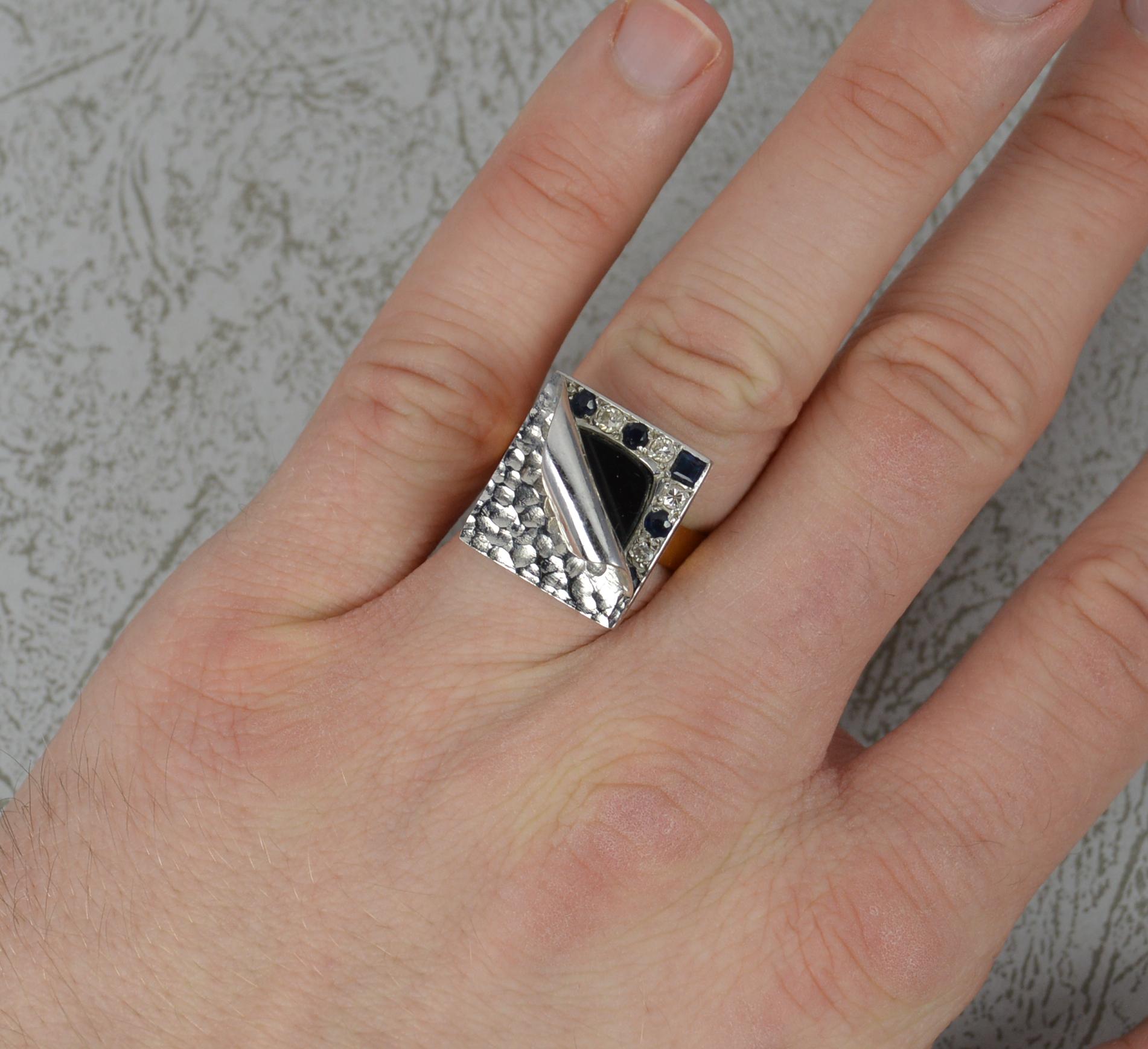 A stunning unique handmade ring.
Solid 18 carat yellow gold shank and white gold head.
Designed with a triangular geometric shaped band. 
The head to measure 15mm x 17mm approx. It features a hammered front design which appears to be peeling back to