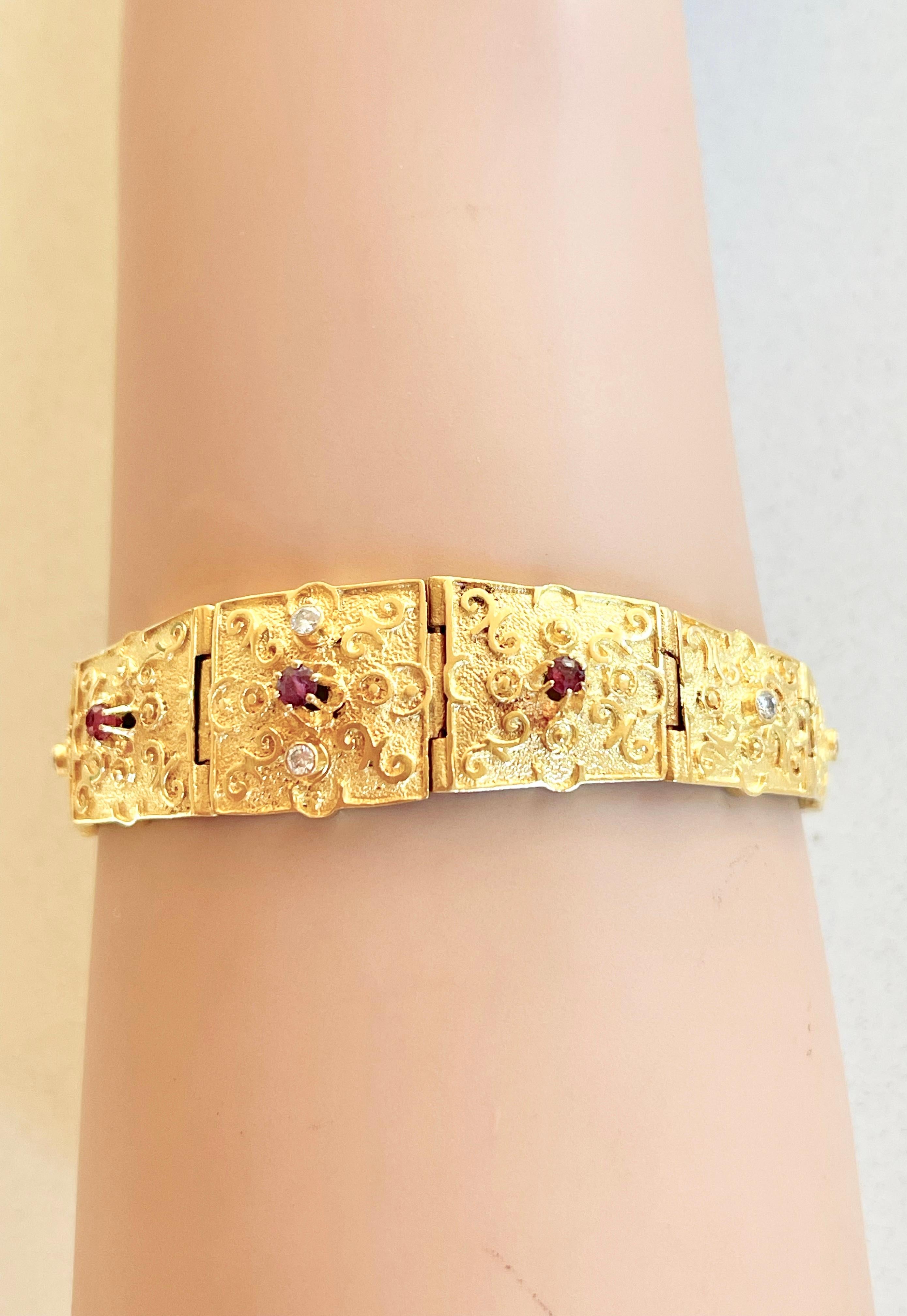 This Unique Bracelet cannot be repeated and the pictures speak for themselves.

The bracelet is solid 18ct gold and weighs 23 grams  The colour of the gold is rich and warm.  It is set with little natural Rubies and Diamonds.  Each panel is also