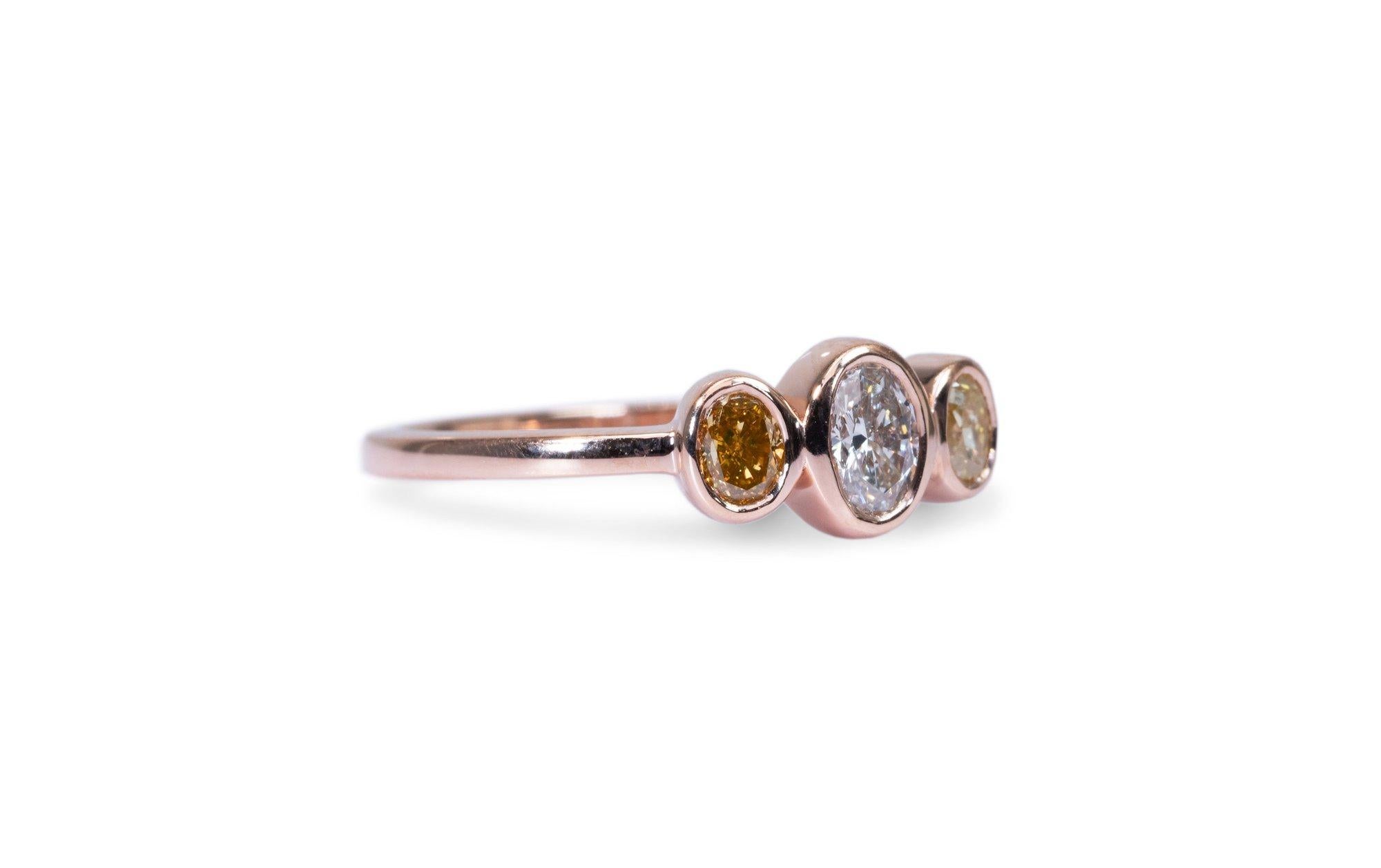 Beautiful and one of a kind 3 stone ring setting made from 18k rose gold with 0.46 carat of oval shape diamond and fancy brownish yellow oval diamonds. This ring comes with an AIG Certificate and a fancy box.

-1 diamond main stone of 0.20 ct.
cut:
