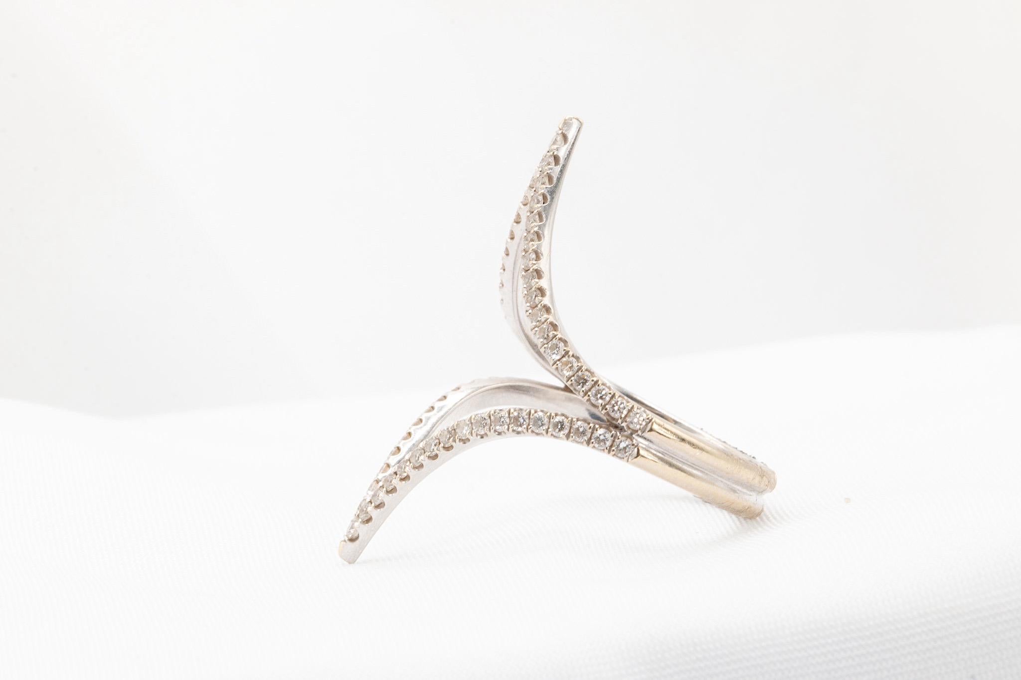 This unique and beautifully pre-owned 18K white gold diamond band exudes timeless elegance. Renewed to enhance its original charm, the band features an estimated 0.75 carats of dazzling diamonds, making it a truly stunning piece. Currently sized at