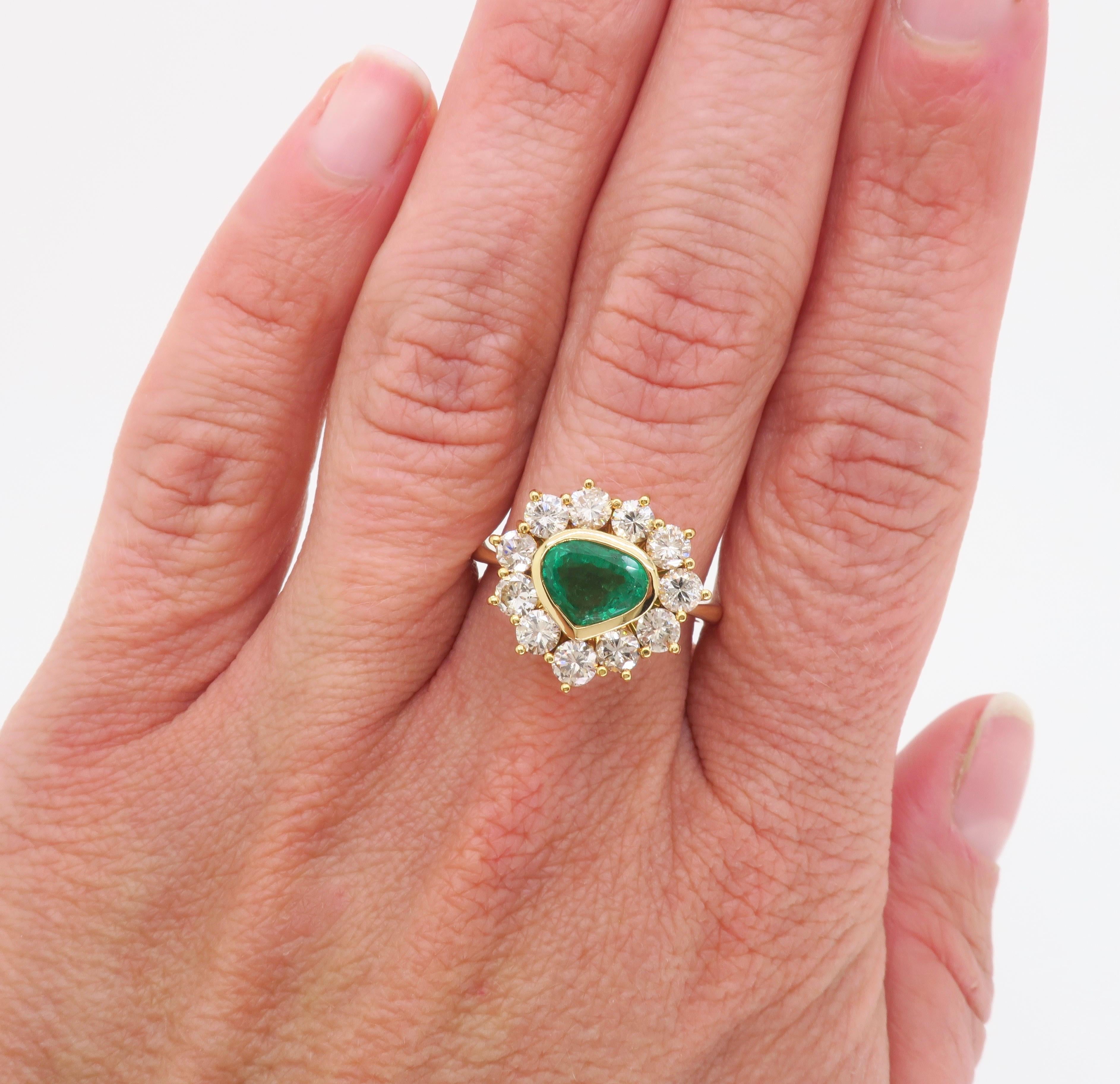 Custom made 18k yellow gold diamond and Emerald halo ring. 

Gemstone: Emerald & Diamond
Diamond Carat Weight:  1.75CTW
Diamond Cut: Round Brilliant Cut 
Color: Average G-I
Clarity: Average SI
Metal: 18k Yellow Gold
Ring Size: 8.25 - sizable 