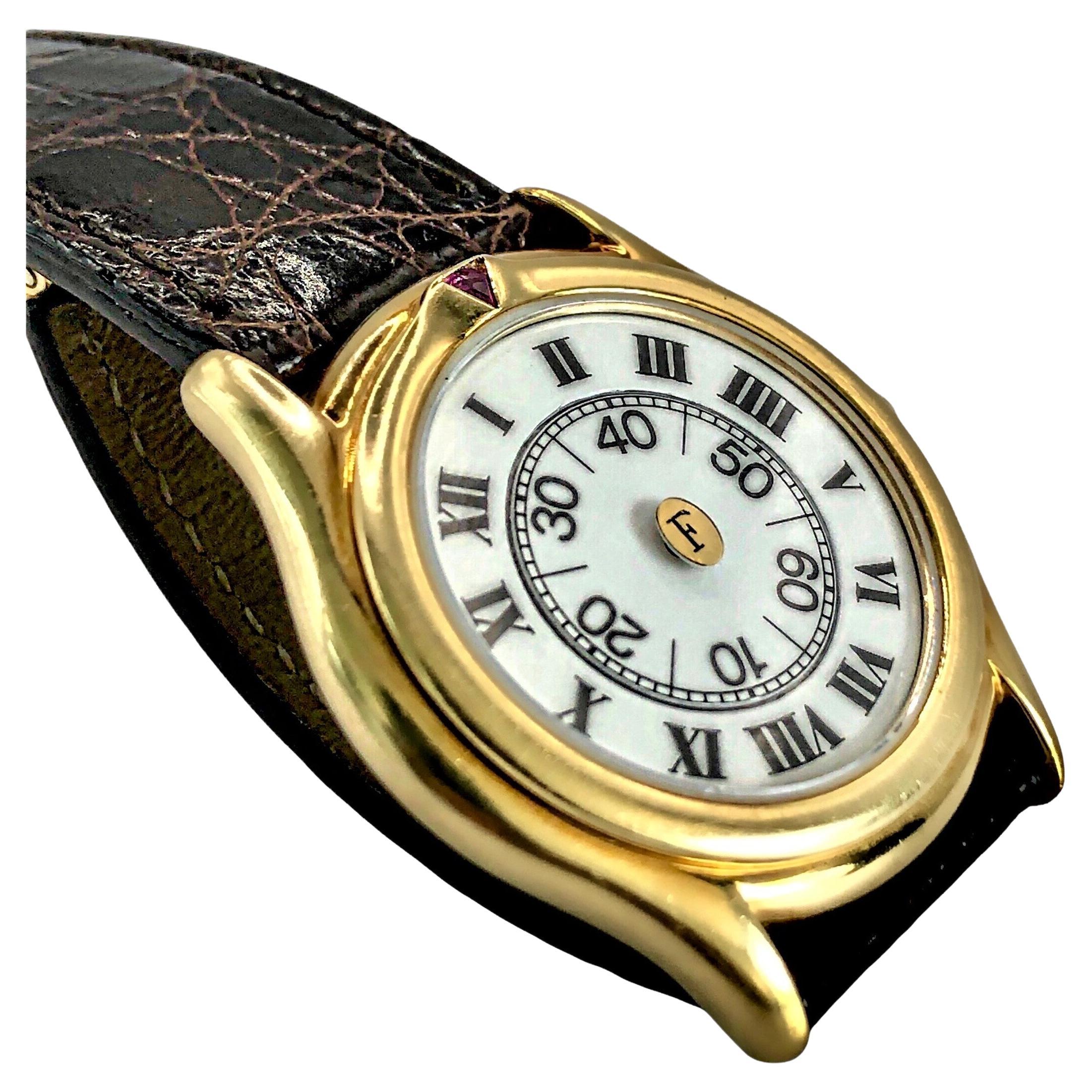 This wonderful 18K yellow gold quartz movement Faraone Italian designer wist watch is among the more interesting and unusual that have ever come our way. With simply a glance, it becomes apparent that the face has no hands. Instead, timekeeping is