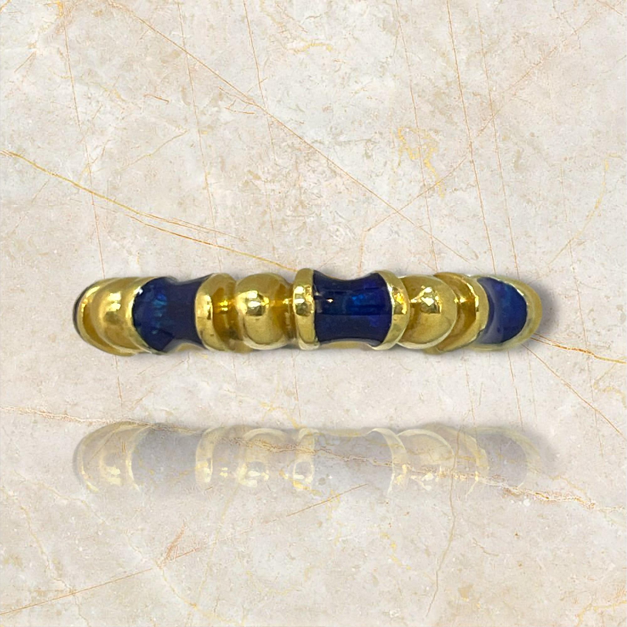 This stunning ring by Tiffany & Co. features a striking blue enamel inlay set in luxurious 18K yellow gold. The bold design and vibrant color make it a standout piece, perfect for adding a touch of elegance and sophistication to any outfit. Whether
