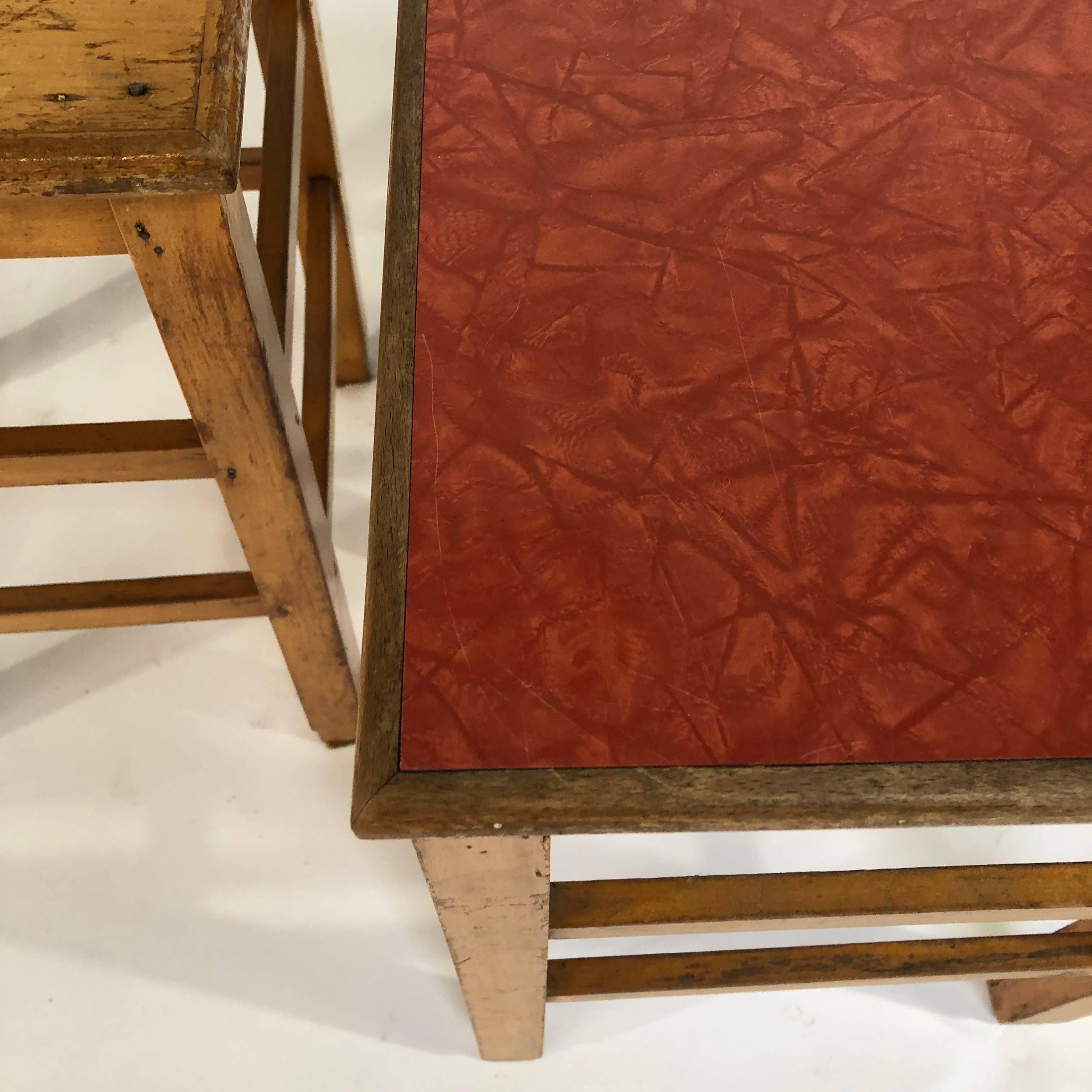 Beautiful patinated wooden school stools. Very nice to use as a side table or just as a stool. 
The stools came from Belgian Boarding school. 
Only 6 stools with a the red formica top and wooden frame left. 