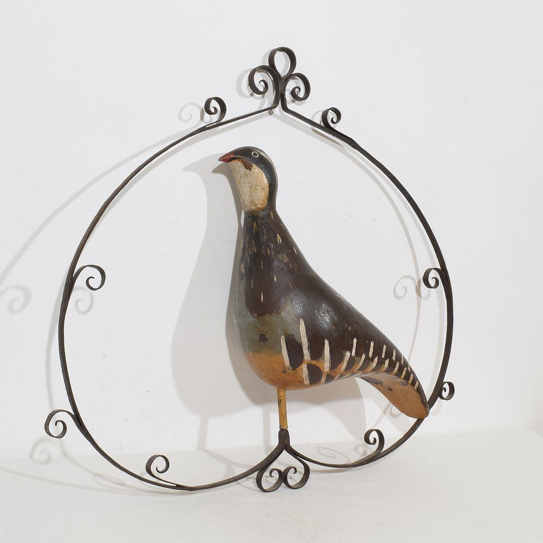 Brilliant and unique shop-sign. 
A painted grouse made out of sheet iron or zinc that is placed within a hand forged iron frame that is made to hang.
France circa 1850-1900
Weathered ( small losses on the paint) but despite of its age in a good