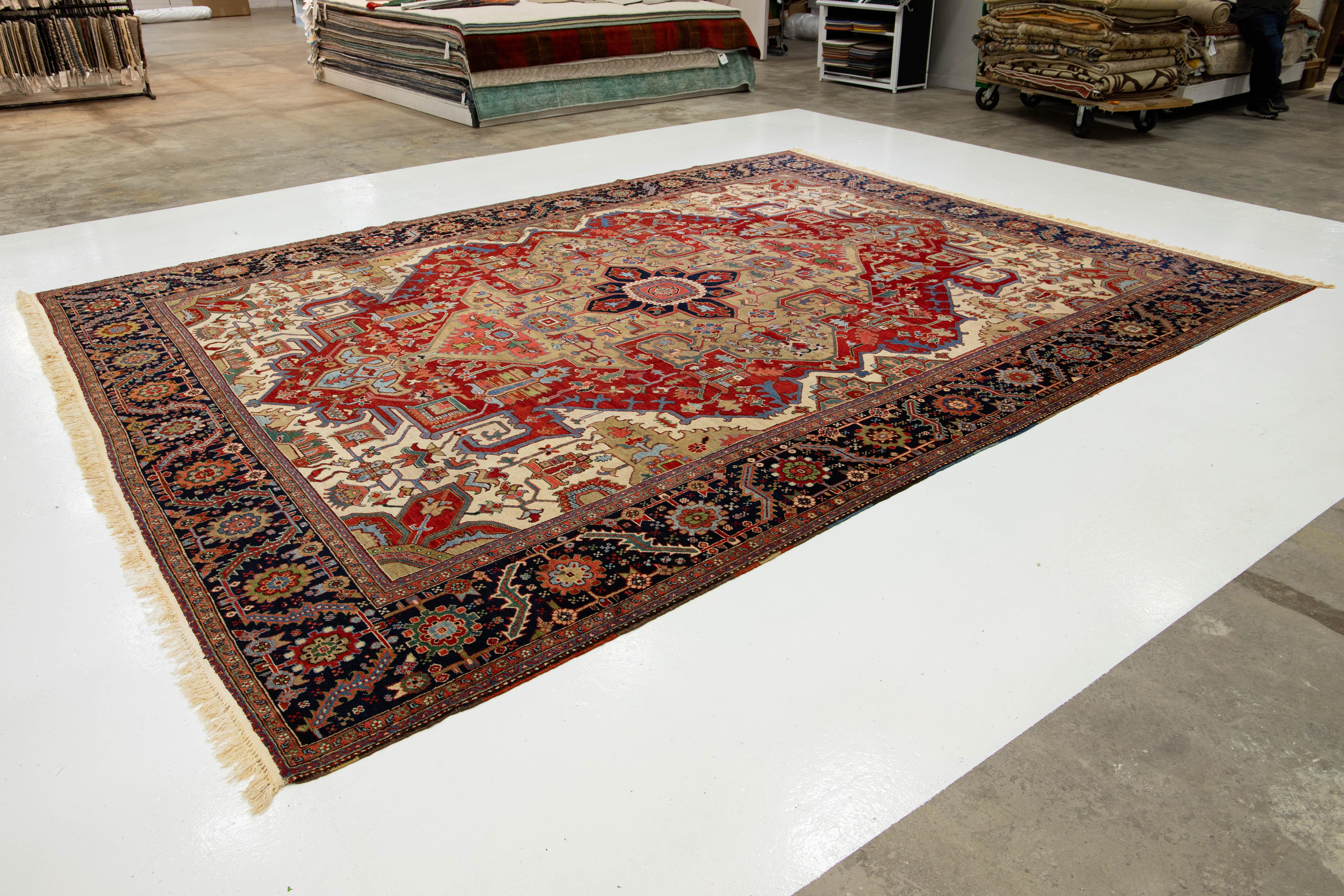 Hand-Knotted Unique 19th Century Persian Serapi Wool Rug Featuring a Red Medallion Design For Sale
