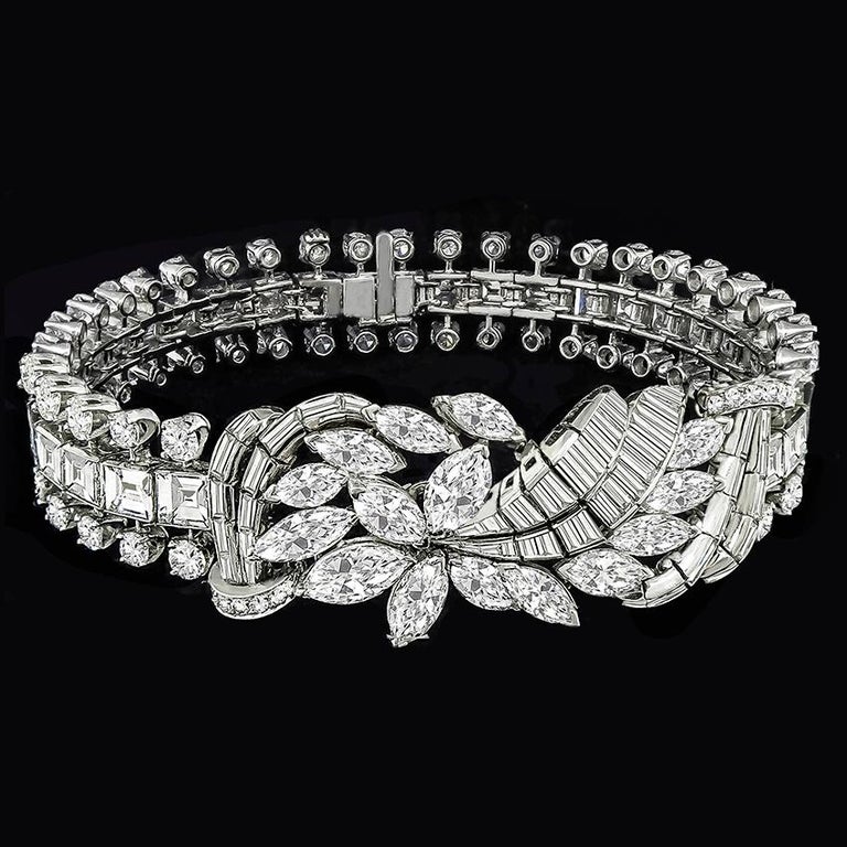 This elegant diamond 18k white gold bracelet is set with sparkling marquise, asscher, baguette and round cut diamonds weighing approx 25ct graded E color VS clarity. The bracelet measures from 12.5mm to 23mm in width, 7 3/4 inches in length, and