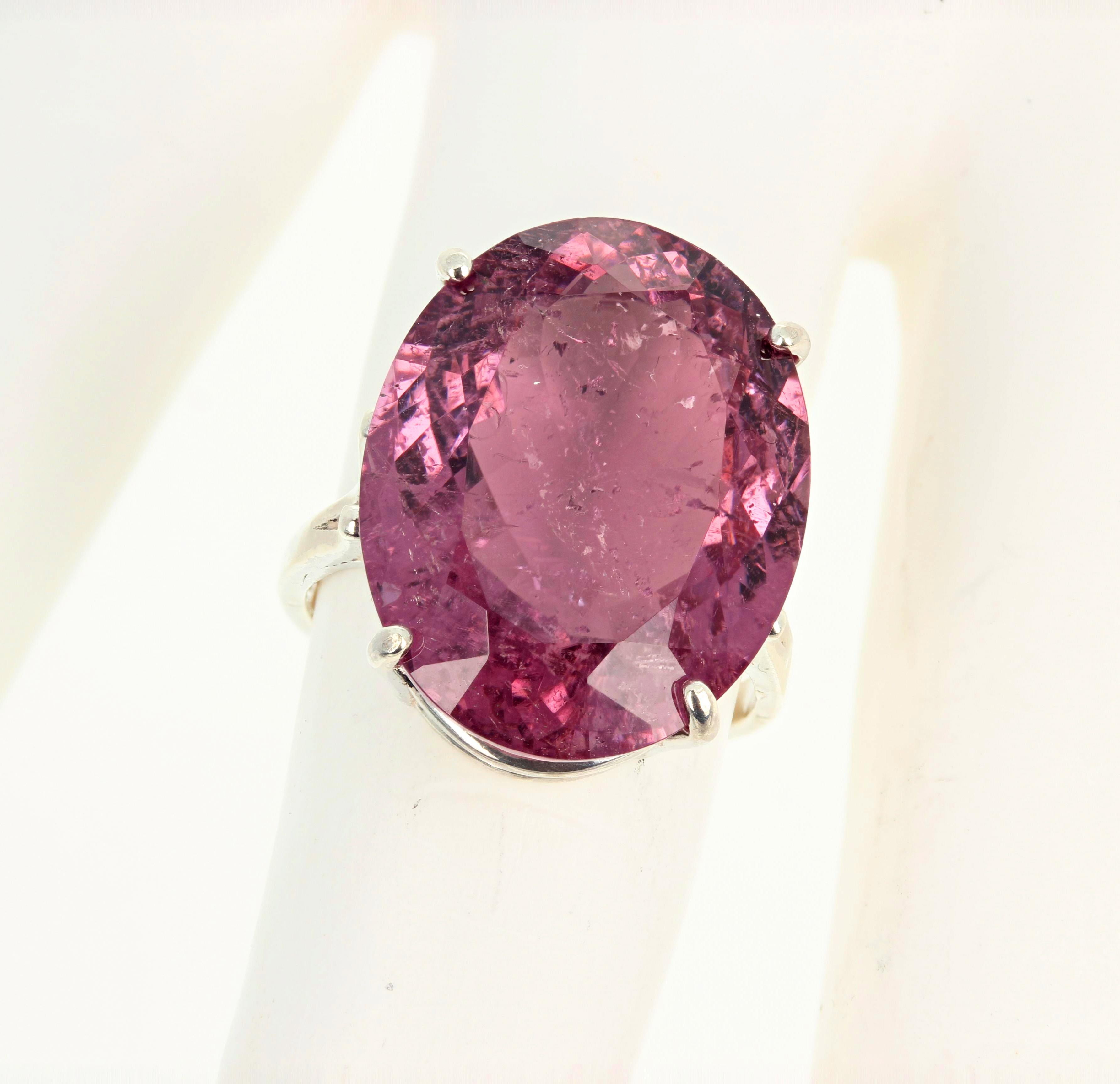 Spectacular optical effects in this unique gorgeous huge 20.04 carat purplypinky natural Tourmaline ring exhibit sparkling silver reflections and pink highlights.  The Gemstone is 20 mm x 16 mm and is set in a sterling silver ring size 7 (sizable