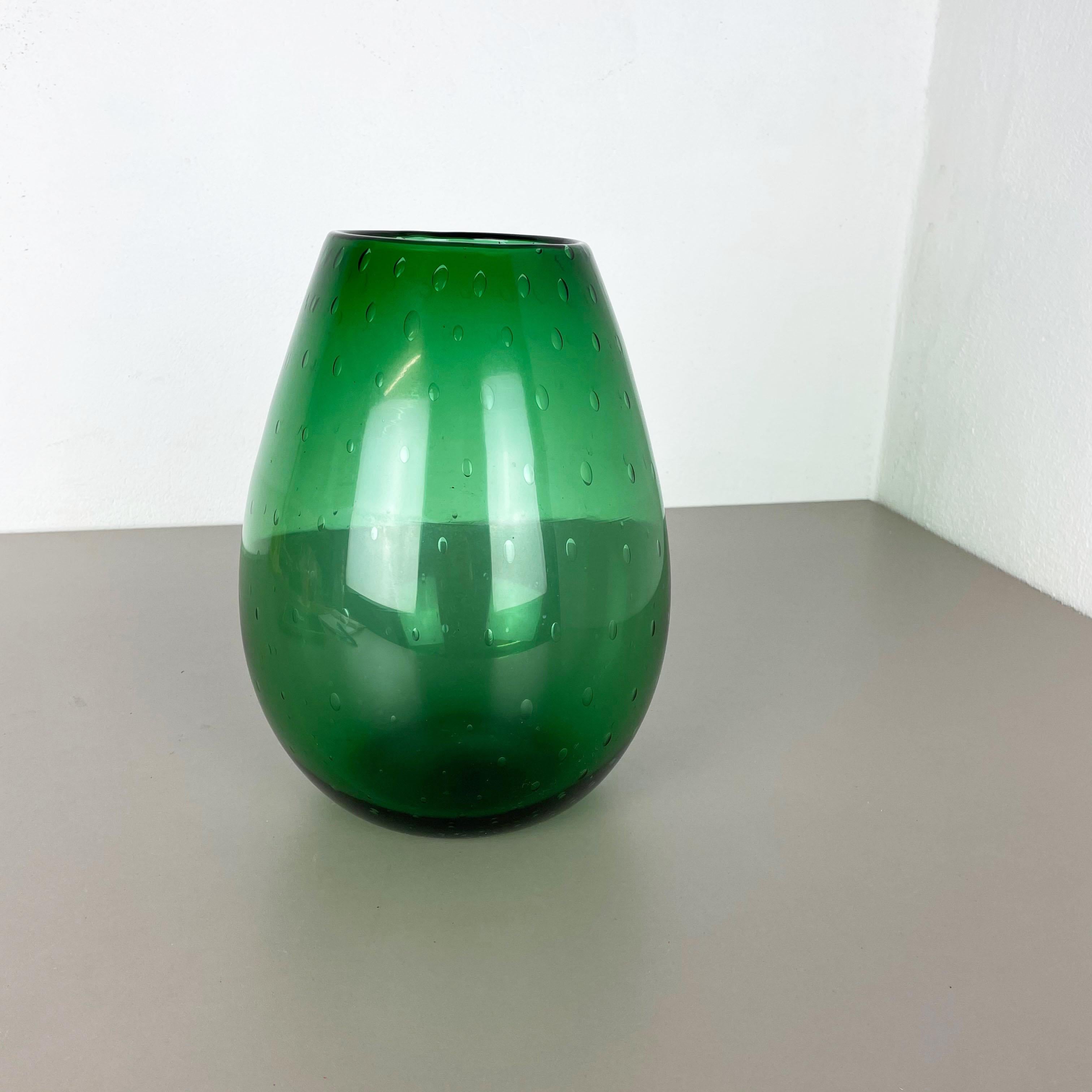 Article:

Murano glass vase element

Origin:

Murano, Italy


Decade:

1970s


This original glass vase was produced in the 1970s in Murano, Italy. An elegant green Murano glass vase utilizing the bullicante technique of controlled