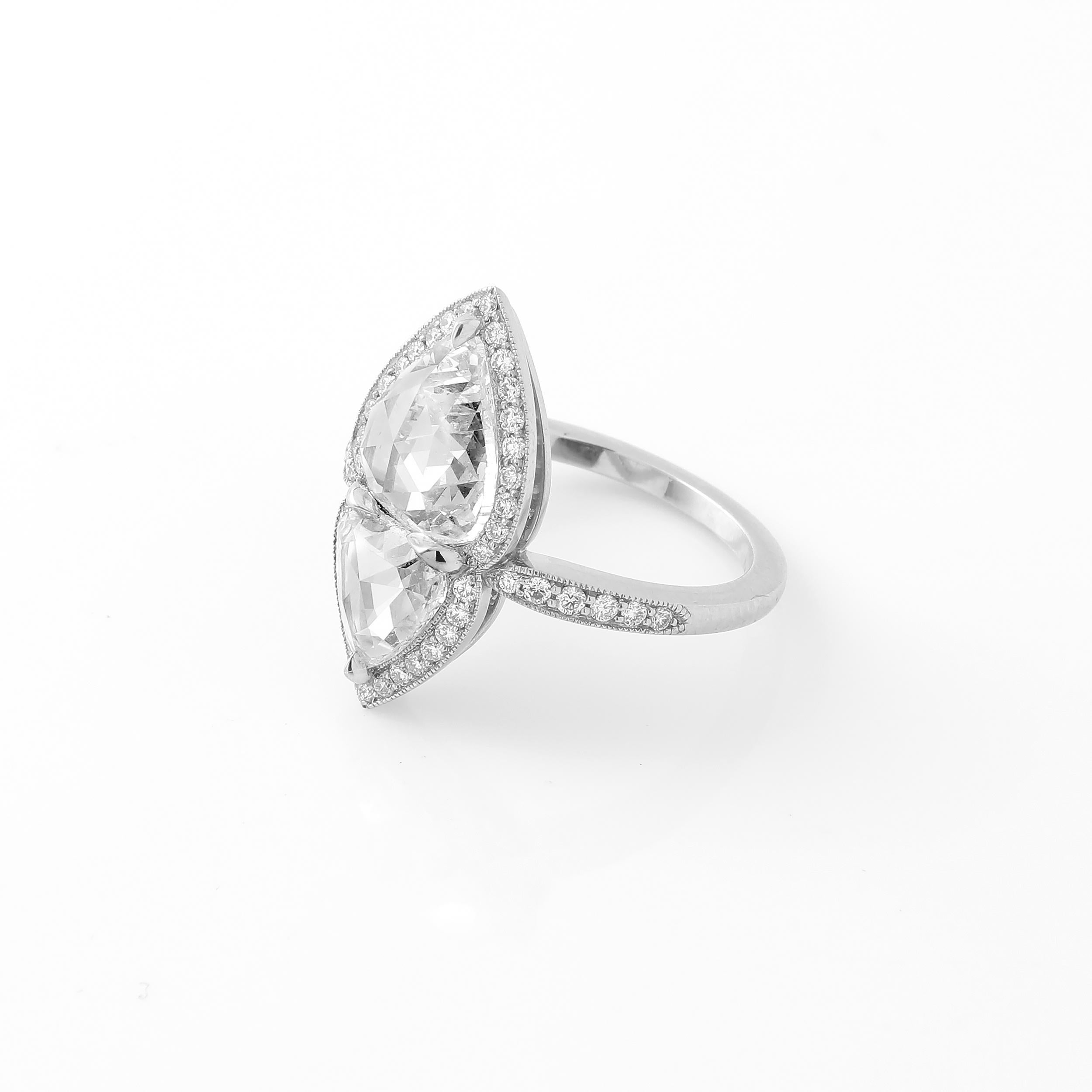 This super unique twin stone or 'Toi et Moi' ring features a pair of rose cut pear shape diamonds weighing 2.32 carats and 0.94 carats. The diamonds 100% natural and approximately G to H color and VS/SI clarity. The stones are set in a beautiful