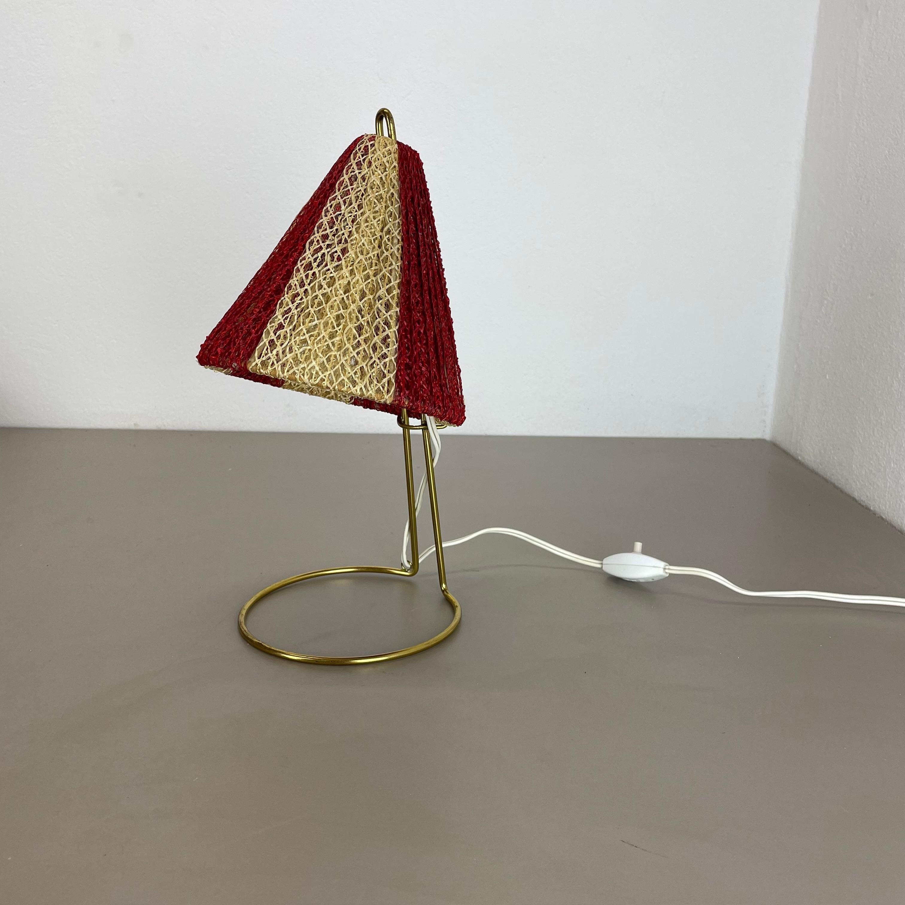 Article:

table light


Origin:

Austria


Age:

1960s


This original vintage table light was designed and produced in the 1960s in Austria. the super rare and minimalist stand element is made of brass combined with 2 upright standing metal parts, 