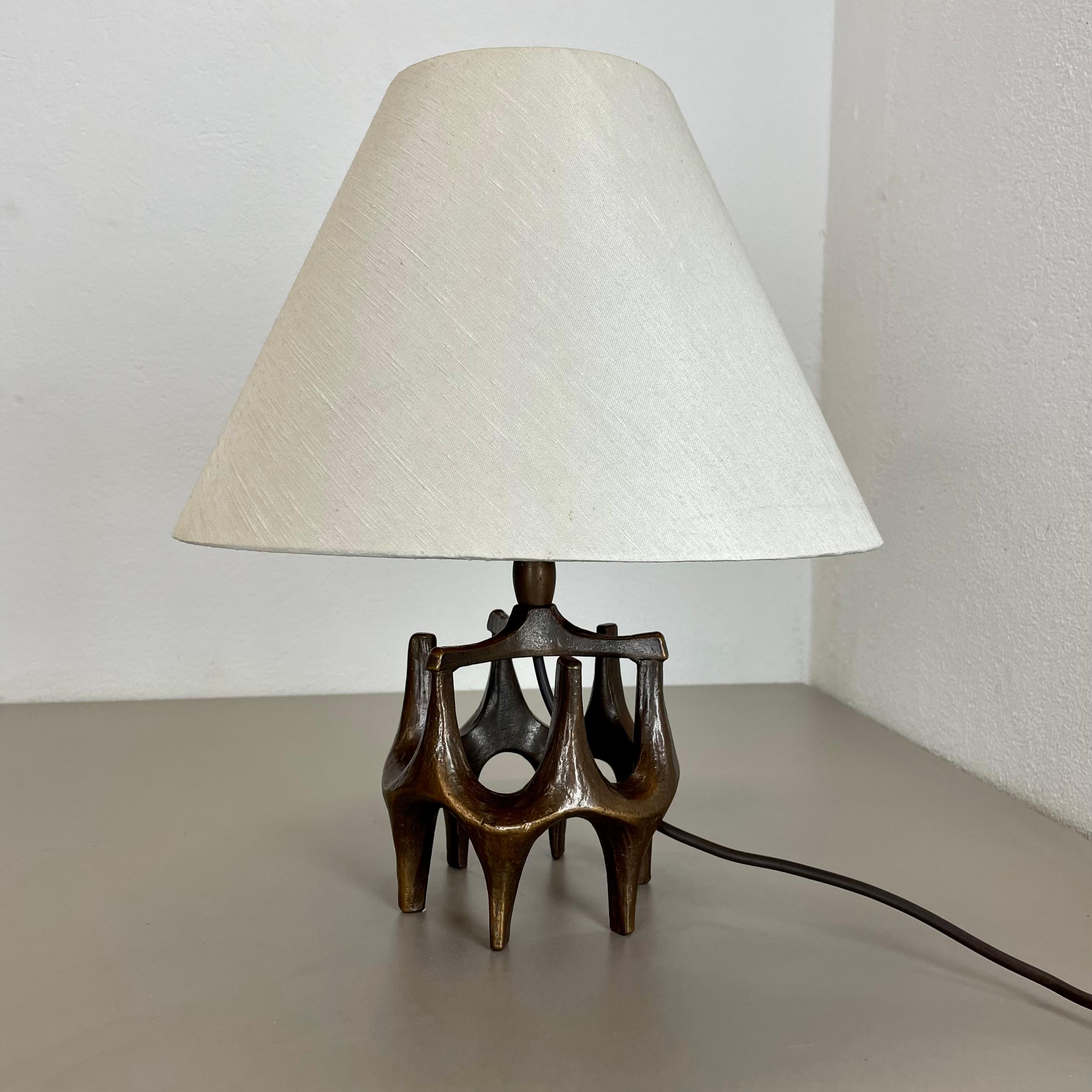 Article: Brutalist table light

Origin: Germany

Design producer: Michael Harjes

Material: bronze

Decade: 1960s

Description: This original vintage table light, was produced in the 1960s in Germany. Designed and executed by Michael Harjes,