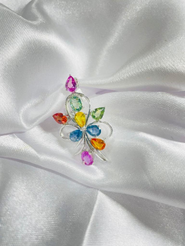 This Modern Multi Sapphire Flower Brooch enhances your attire and is perfect for adding a touch of elegance and charm to any outfit. Crafted with exquisite craftsmanship and adorned with dazzling multi sapphire which calms the senses and increases